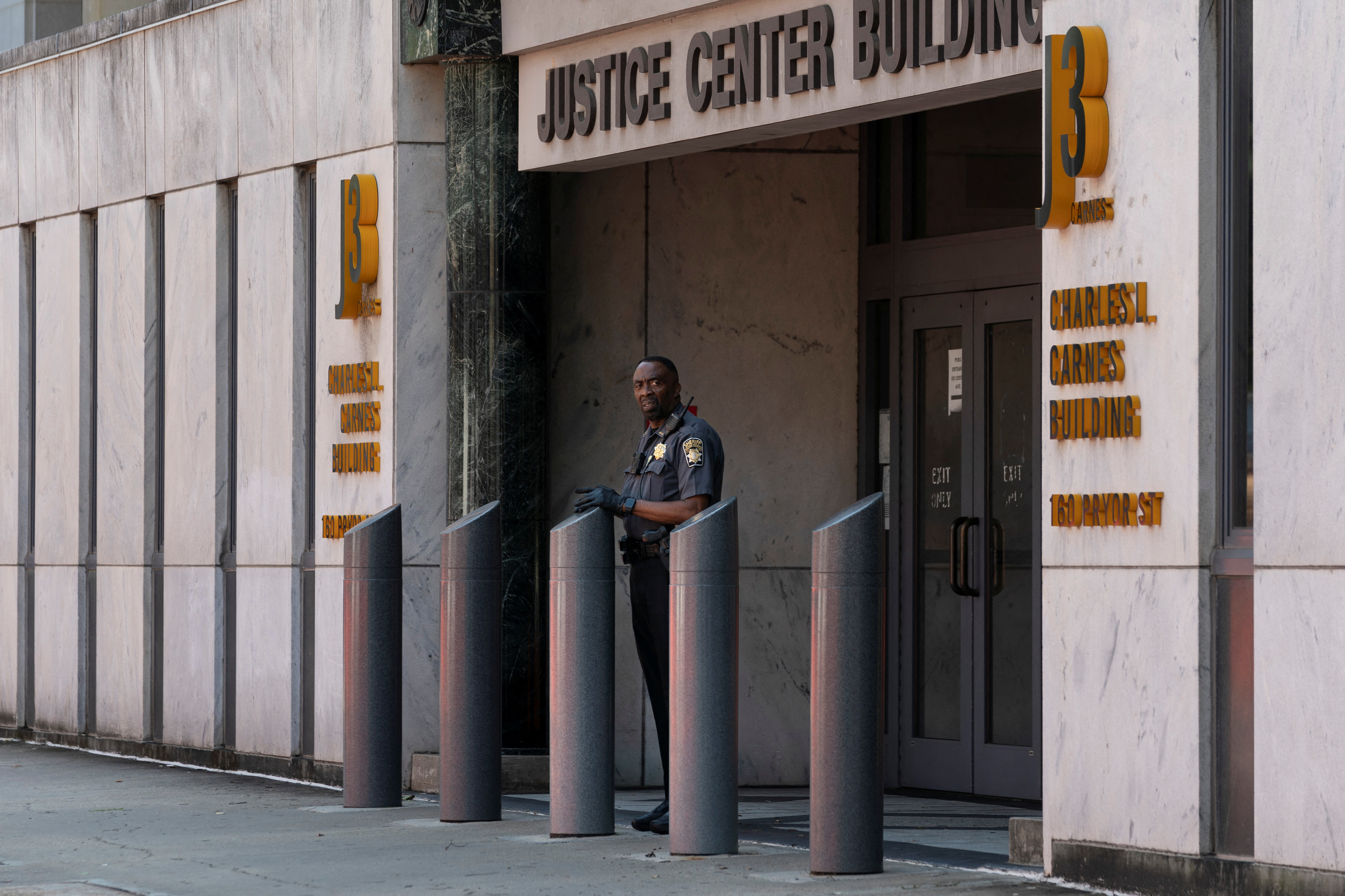 A Sheriff's deputy is seen outside the Fulton County Superior Court after the Fulton County Sheriff ordered roads to be closed as officials tighten security as the city prepares for a possible criminal indictment of former U.S. President Donald Trump for his attempts to overturn his election defeat in the state, in Atlanta, Georgia, U.S. August 7, 2023. REUTERS/Elijah Nouvelage