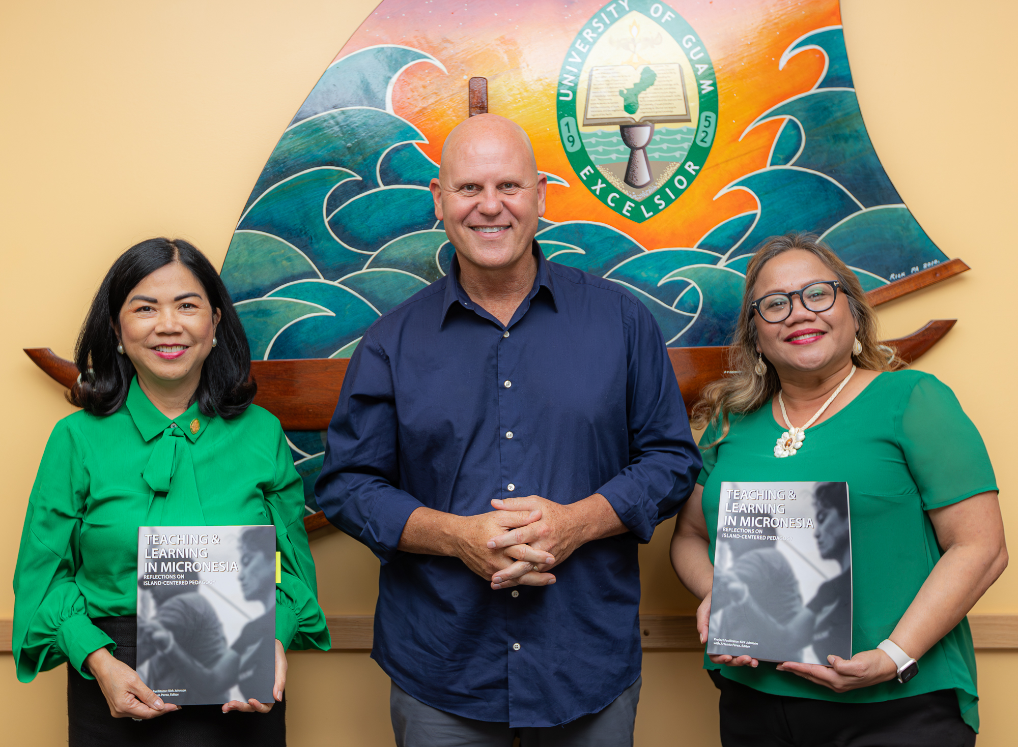University of Guam President Dr. Anita Borja Enriquez, first from left, holds a copy of the book “Teaching & Learning in Micronesia: Reflections on Island Centered Pedagogy.” Enriquez is joined by Dr. Kirk Johnson, center, UOG professor of sociology who facilitated the book project, and Interim Senior Vice President and Provost Dr. Sharleen Santos-Bamba.
