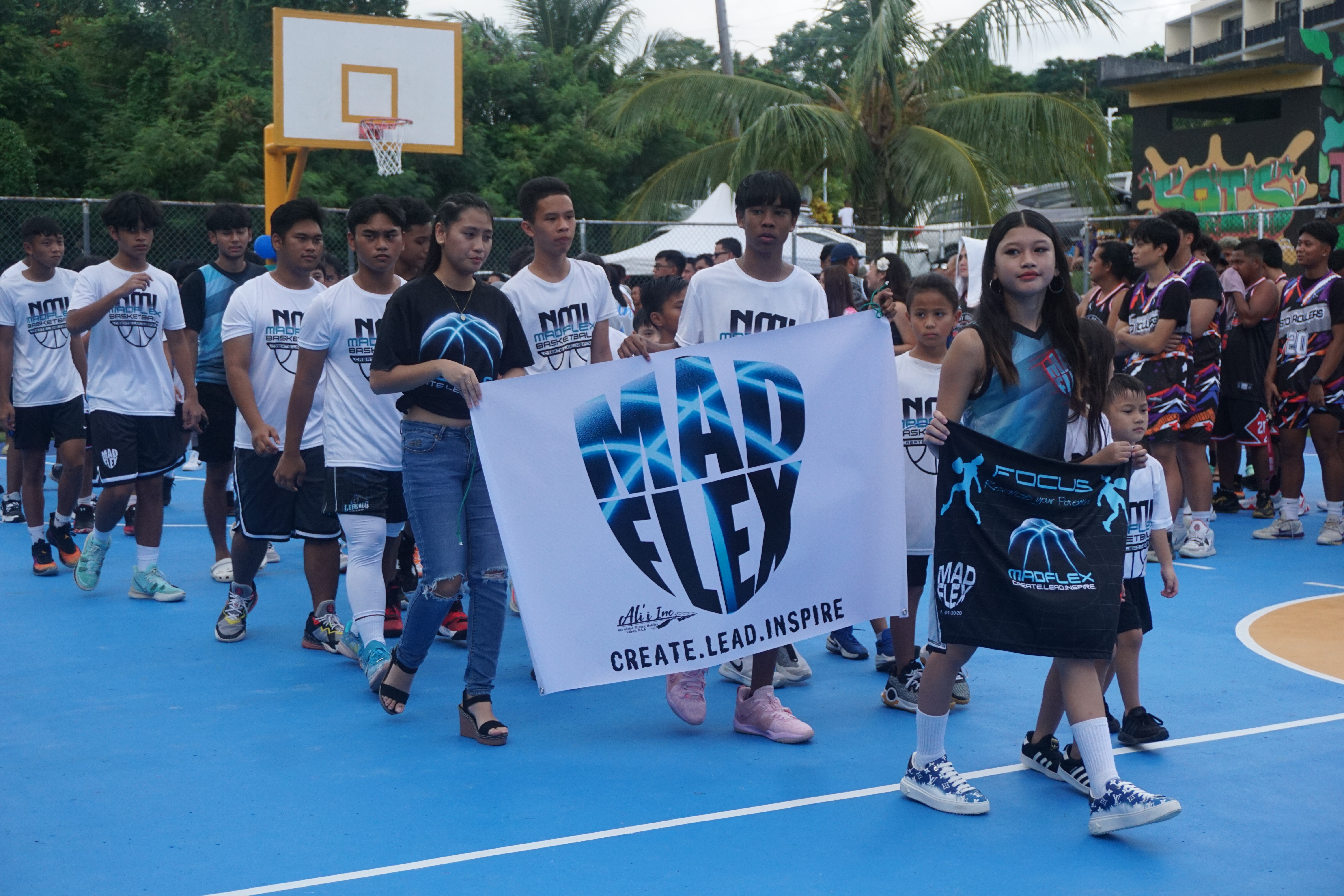 MadFlex Basketball Club members make their way to the judges’ table during the opening ceremony of the 2023 Saipan MagaLahi Eagles Club Invitational Basketball League on Sunday at the Gualo Rai basketball court.