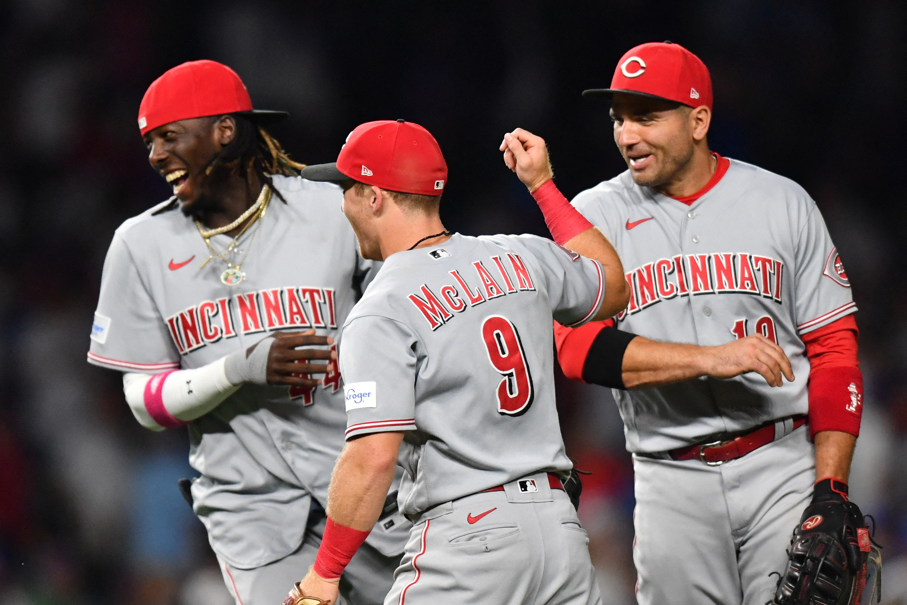 Cincinnati Reds third baseman Elly De La Cruz (44), shortstop Matt McLain (9), and first baseman Joey Votto (19) celebrate their victory over the Chicago Cubs at Wrigley Field in Chicago, Illinois, July 31, 2023.