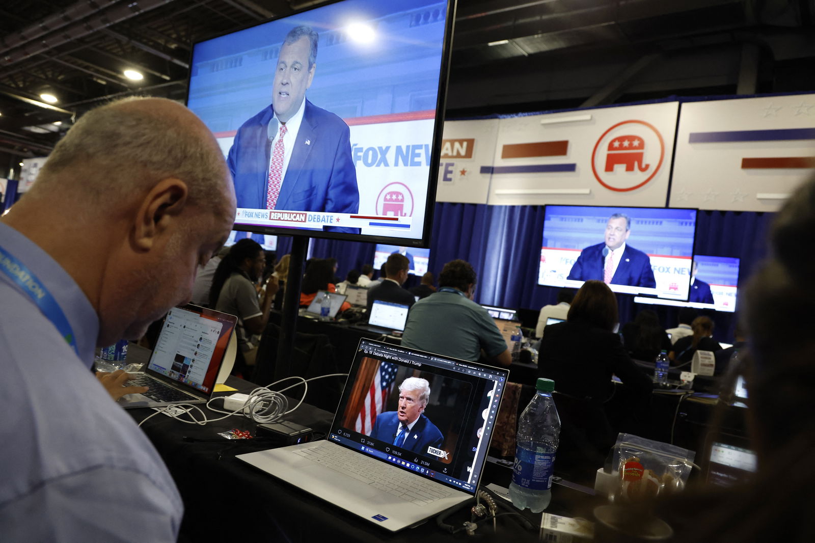 A reporter watches former President Donald Trump's online interview with Tucker Carlson in the media filing center during the first Republican candidates' debate of the 2024 U.S. presidential campaign in Milwaukee, Wisconsin, U.S. August 23, 2023. REUTERS/Jonathan Ernst