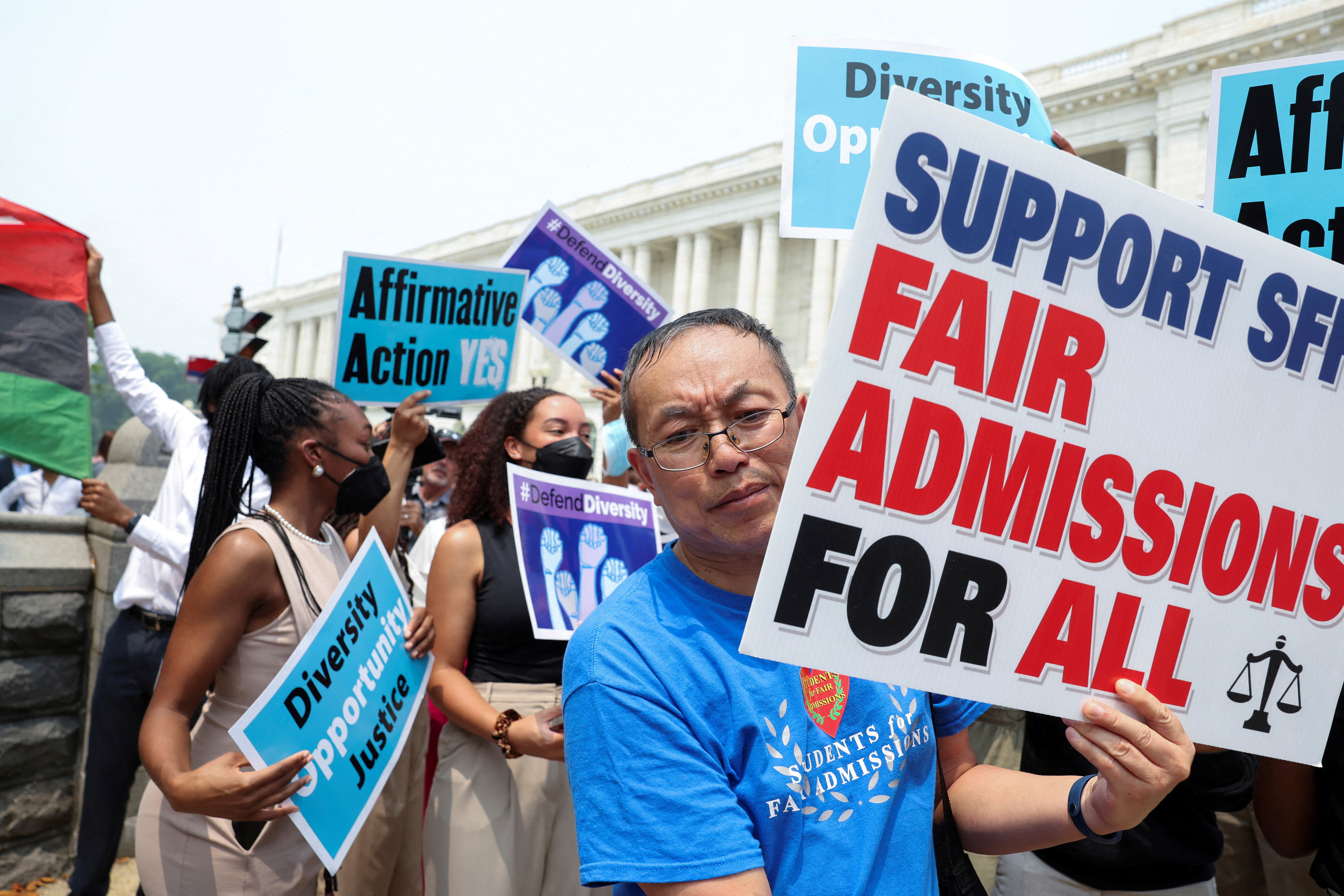 Demonstrators for and against the U.S. Supreme Court decision to strike down race-conscious student admissions programs at Harvard University and the University of North Carolina confront each other, in Washington, U.S., June 29, 2023. REUTERS/Evelyn Hockstein/File Photo