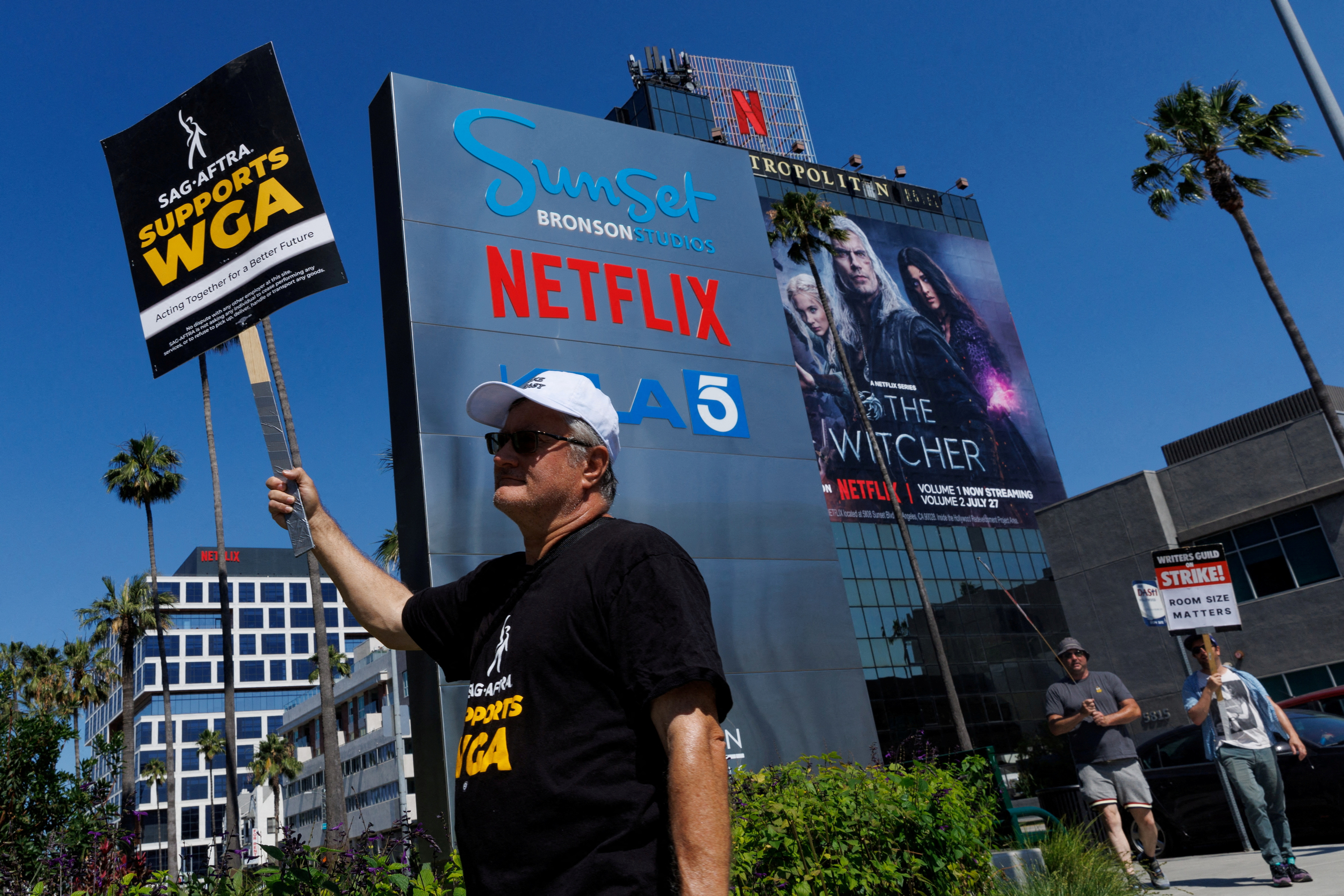 Striking Writers Guild of America (WGA) members walk the picket line in front of Netflix offices as SAG-AFTRA union announced it had agreed to a 'last-minute request' by the Alliance of Motion Picture and Television Producers for federal mediation, but it refused to again extend its existing labor contract past the 11:59 p.m. Wednesday negotiating deadline, in Los Angeles, California, U.S., July 12, 2023. REUTERS/Mike Blake/File Photo
