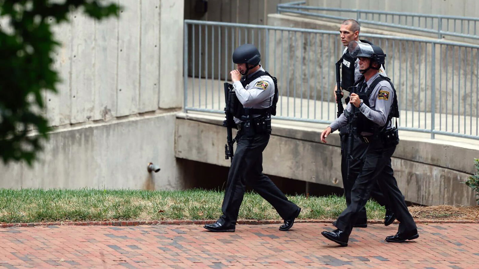 North Carolina Highway Patrol troopers move around a building near South Street near the Bell Tower on the campus of the University of North Carolina in Chapel Hill, North Carolina, on Monday afternoon, Aug. 28, 2023 after a report of a “armed and dangerous person”. (Kaitlin McKeown/News & Observer/TNS)