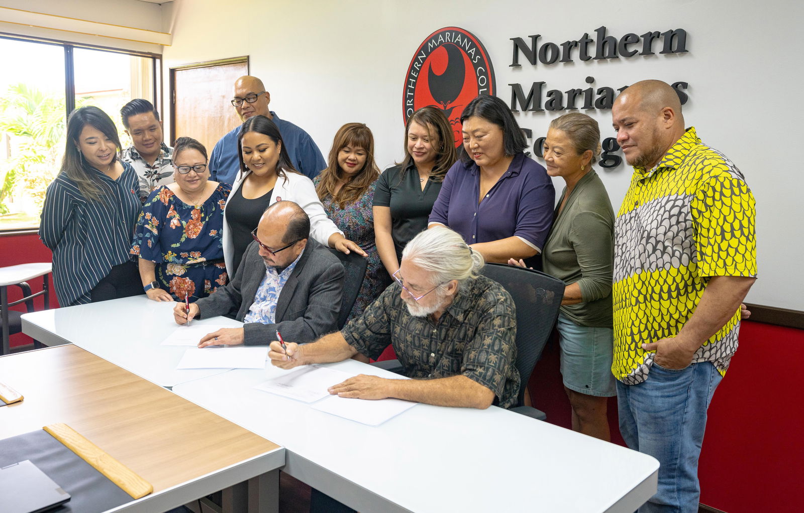 As part of the ongoing effort to develop the CNMI workforce and preserve the Commonwealth’s cultural heritage, Northern Marianas College’s Community Development Institute has recently signed an agreement with 500 Sails. The partnership will offer cultural maritime education programs, including basic seamanship training, traditional canoe fabrication and repair, and traditional sailing and voyaging. Pictured here are NMC President Galvin Deleon Guerrero, EdD, and 500 Sails Acting Executive Director Peter Perez, alongside NMC staff and 500 Sails representatives. (Story on page 5)