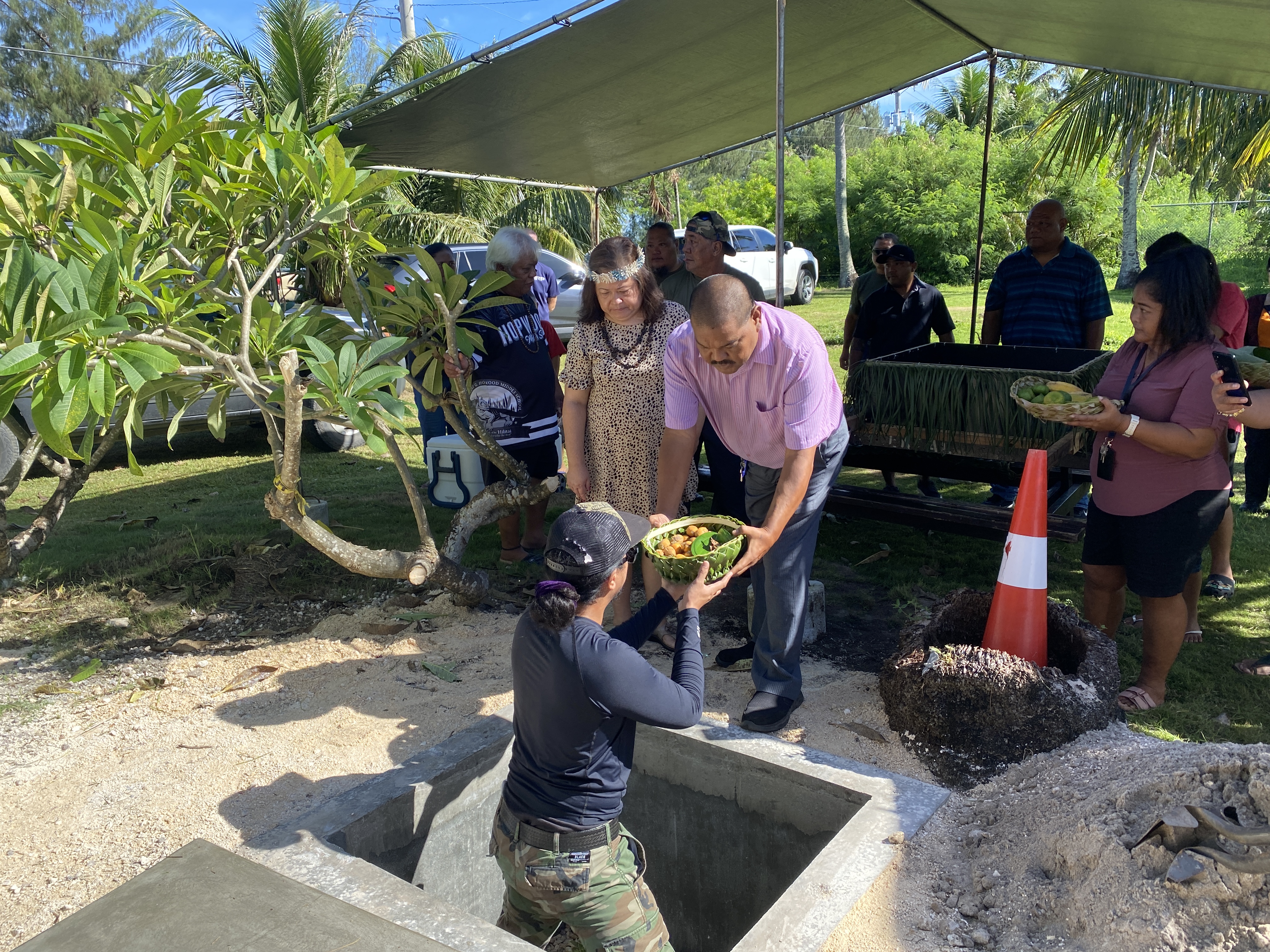 Ross Manglona, in this image from August of this year, brings an offering to a reinterment site of ancestral Chamorro remains. The Office of Indigenous Affairs helped coordinate the event.