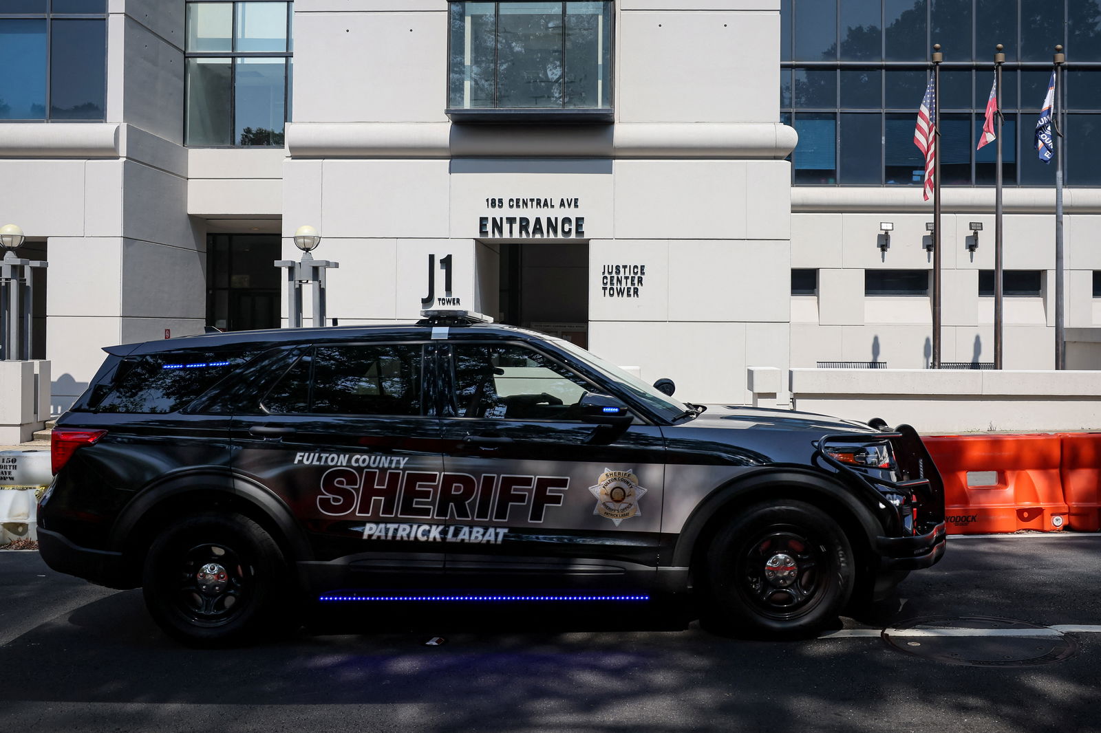 A Sheriff vehicle passes by the Fulton County Justice Center, after a Grand Jury brought back indictments against former U.S. President Donald Trump and 18 of his allies in their attempt to overturn the state's 2020 election results, in Atlanta, Georgia, U.S. August 23, 2023. REUTERS/Brendan McDermid/File Photo