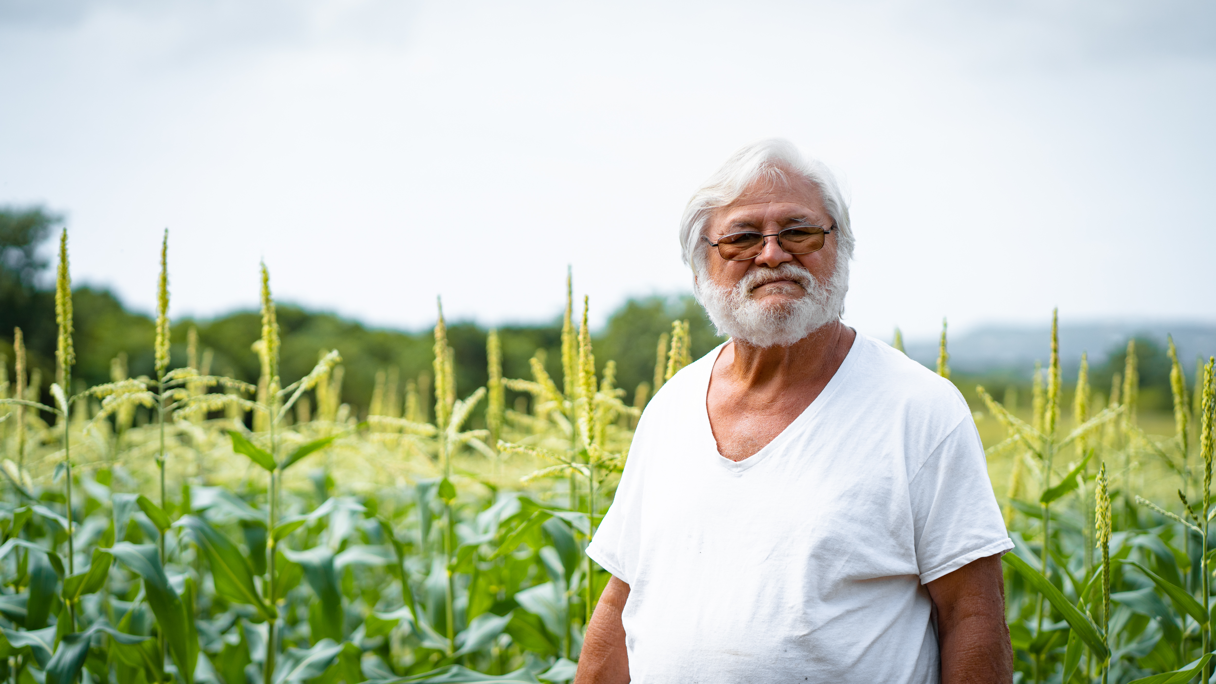 Guam farmer Ernie Wusstig stands in his corn field in Dededo in 2021.
