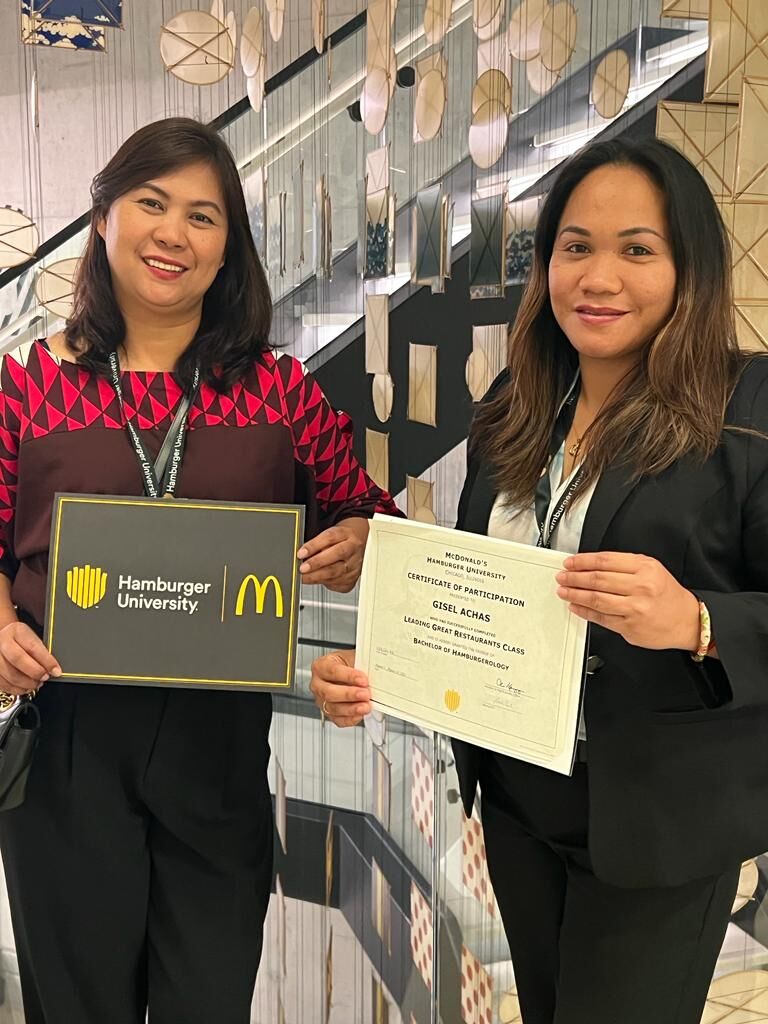 McDonald’s Guam and Saipan managers Leah Laxamana and Gisel Achal pose for a photo while displaying their certificates from Hamburger University in Chicago after completing the "Leading Great Restaurants" course.