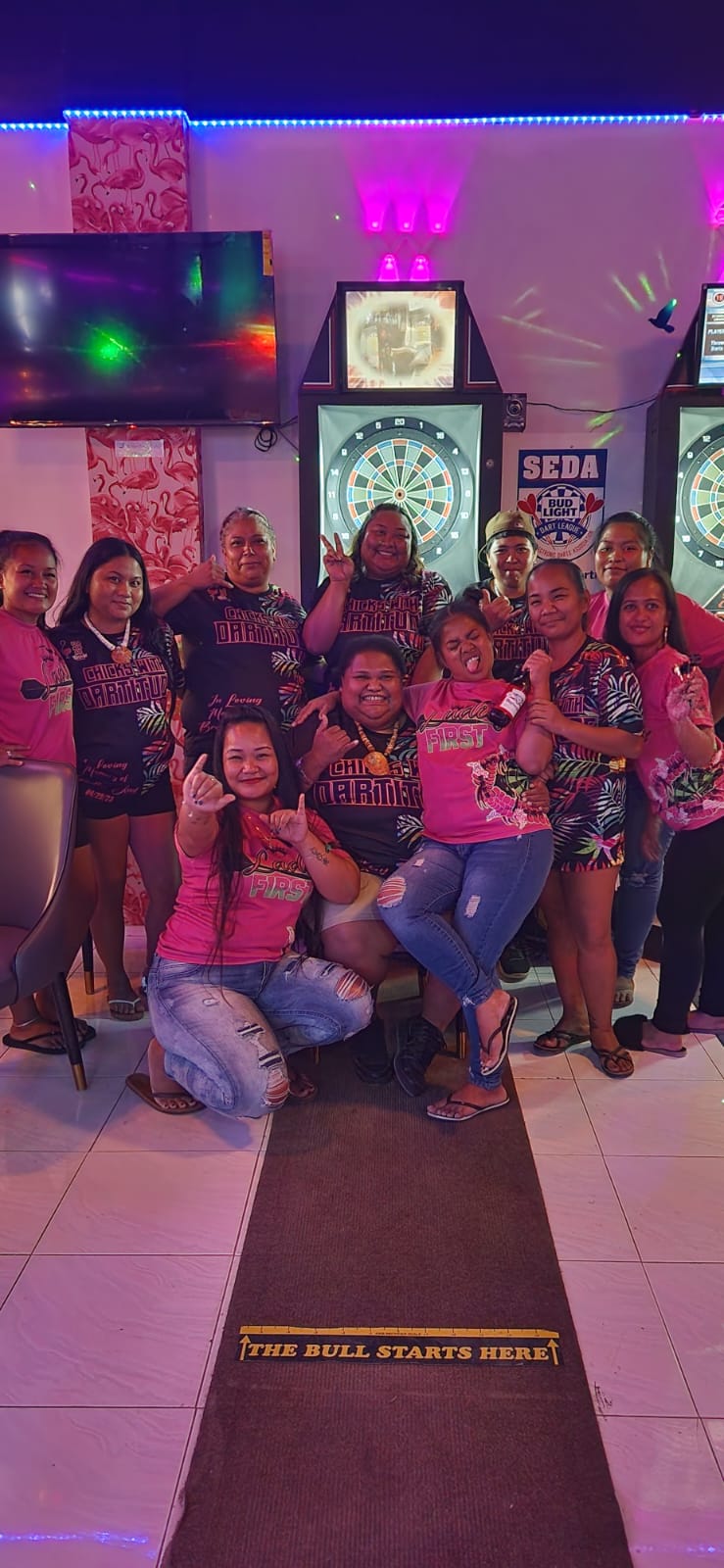 The Flamingo Chicks w/ Dartitude and the Salt&Pepper Ladies First pose for a photo during their ladies division game in the 2023 SEDA Bud Light Dart League on Monday at the Flamingo Tavern.