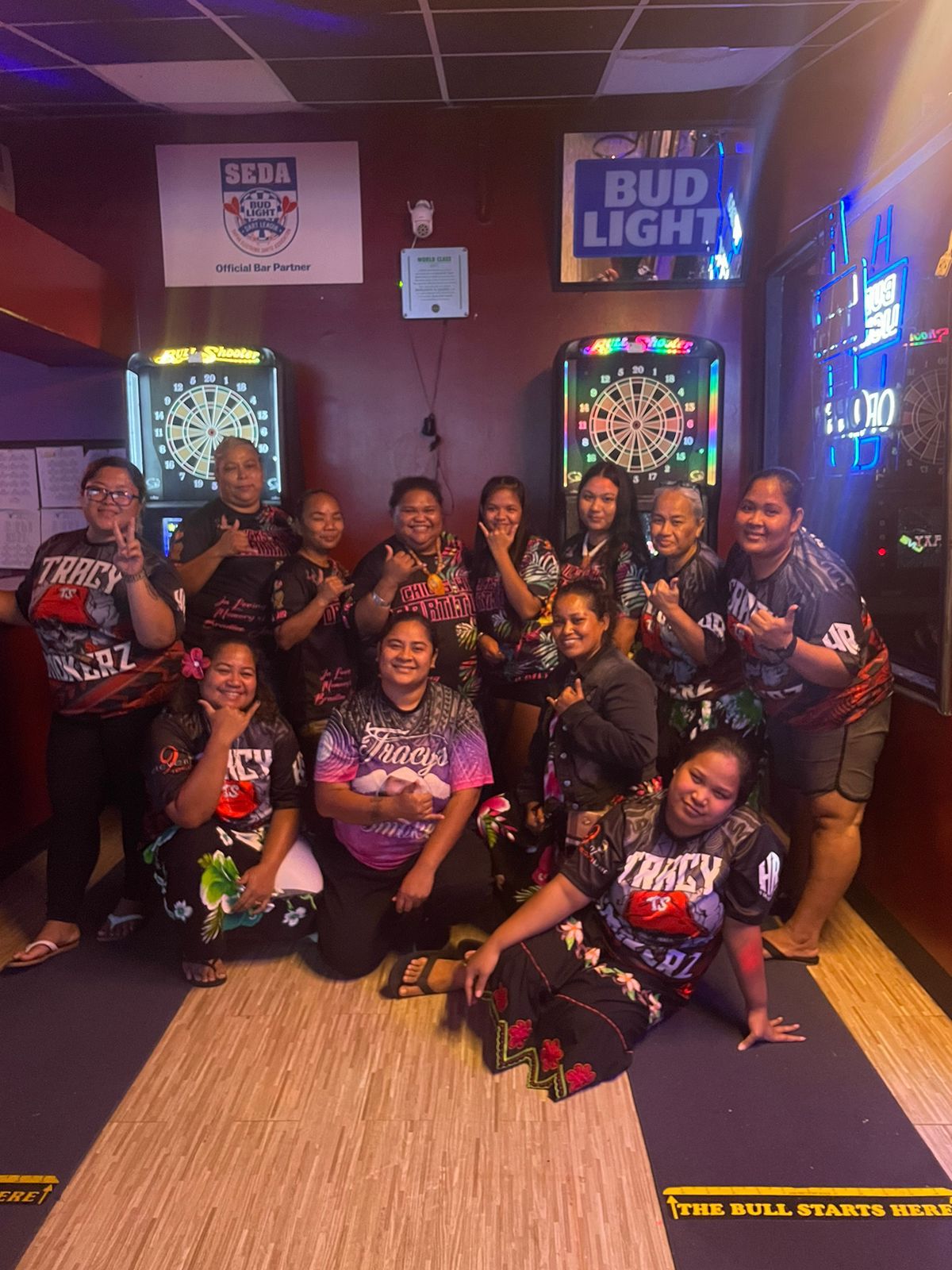 The Flamingo Chicks w/ Dartitudes and the 9 Eleven Tracy's Smokers pose for a photo during their game in the ladies division of the 2023 SEDA Bud Light Dart League on Monday at 9 Eleven Restobar.