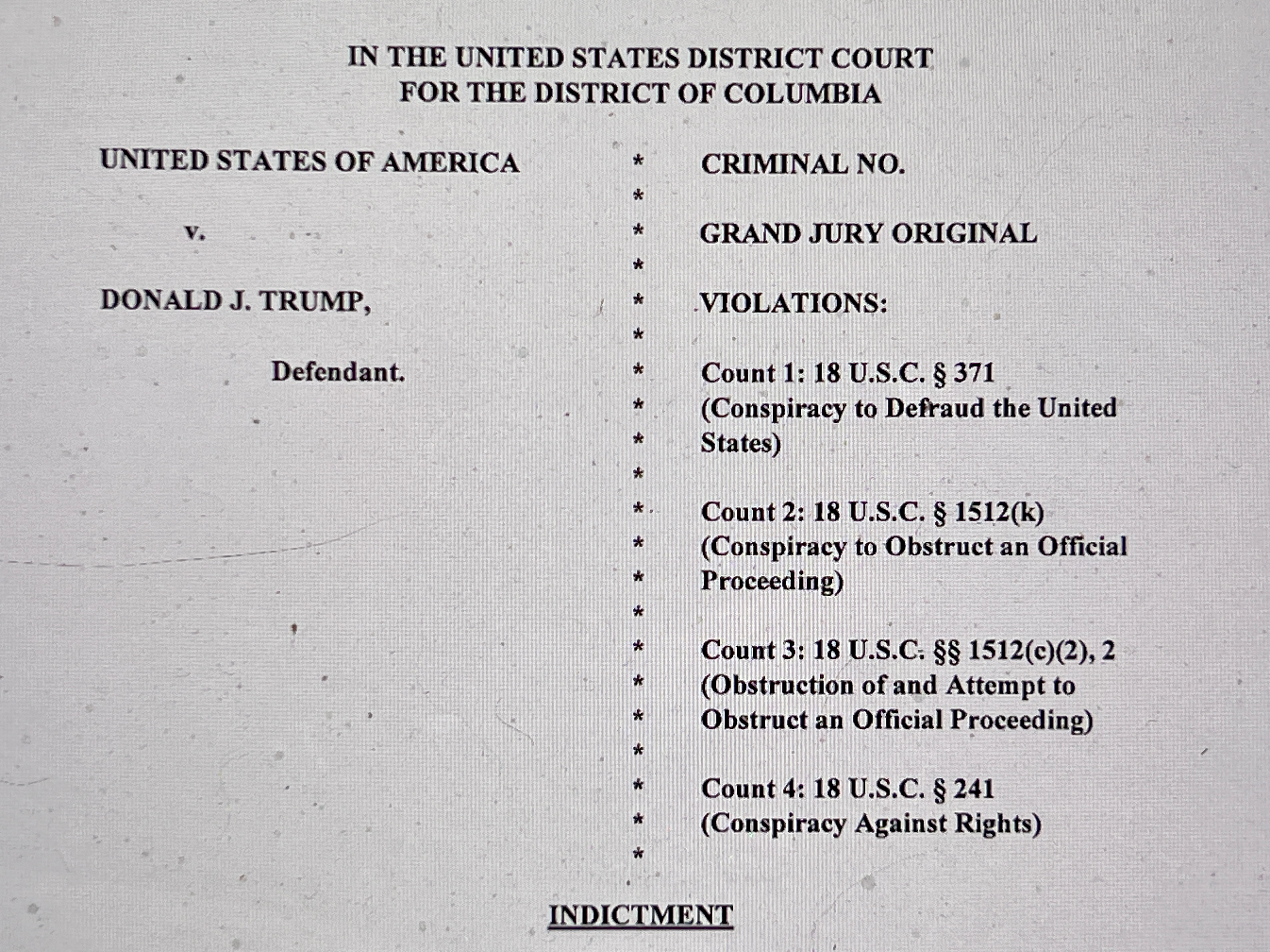 The opening page of an indictment against former U.S. President Donald Trump is seen after he was hit with criminal charges for a third time in four months, in a photo illustration August 1, 2023. REUTERS/Chris Helgren/Photo Illustration