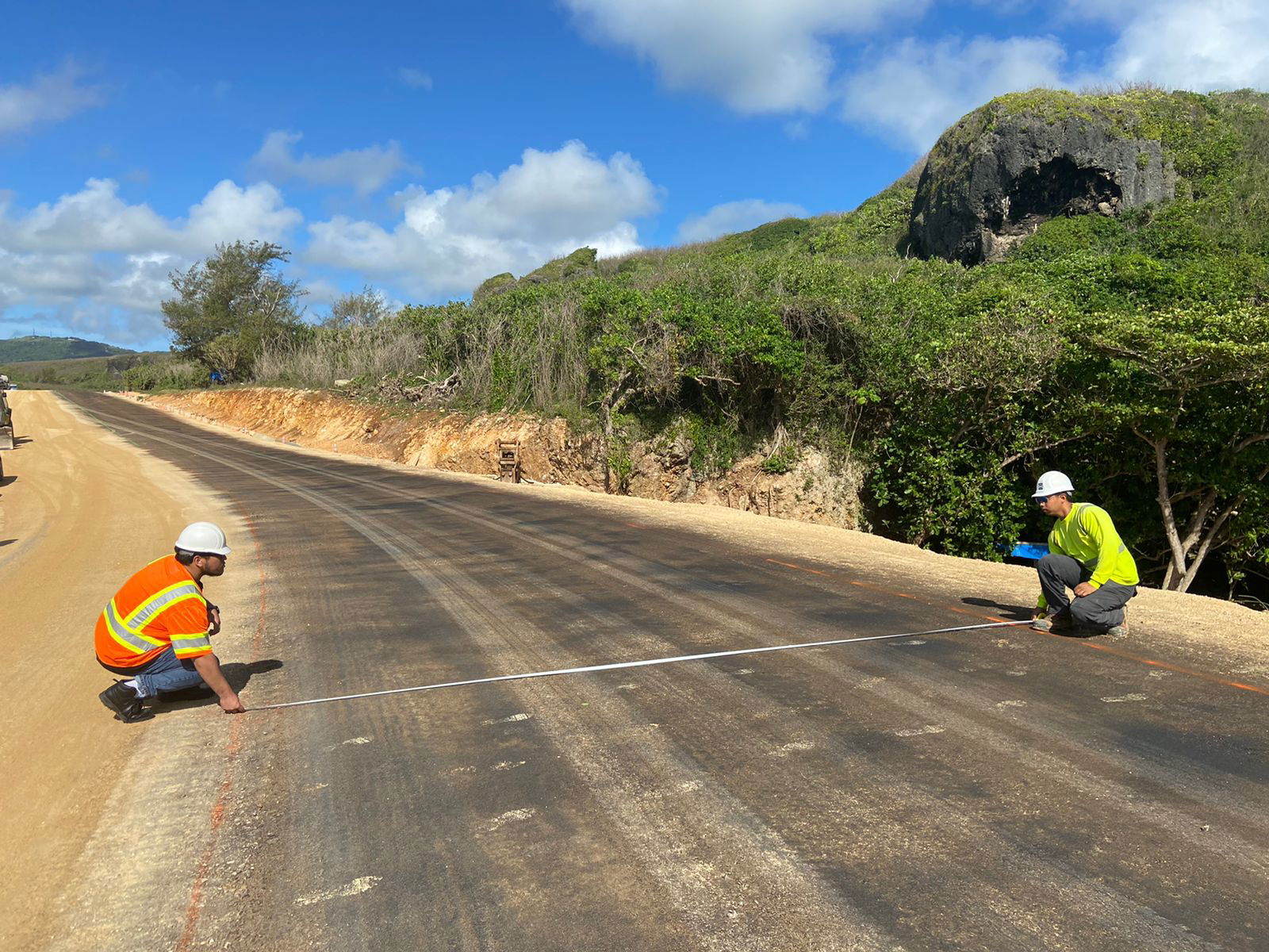 NMC pre-engineering student William Deleon Guerrero, left, measures the road at the ongoing Route 36 project with GHD Construction Inspector Peter Babauta, EIT.