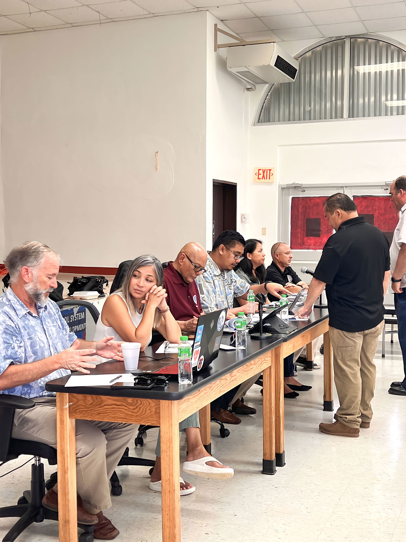 Commissioner of Education Dr. Alfred B. Ada and Public School System legal counsel Michael Ernest confer with some of the members of the Board of Education prior to the start of the regular meeting on Tinian Wednesday.