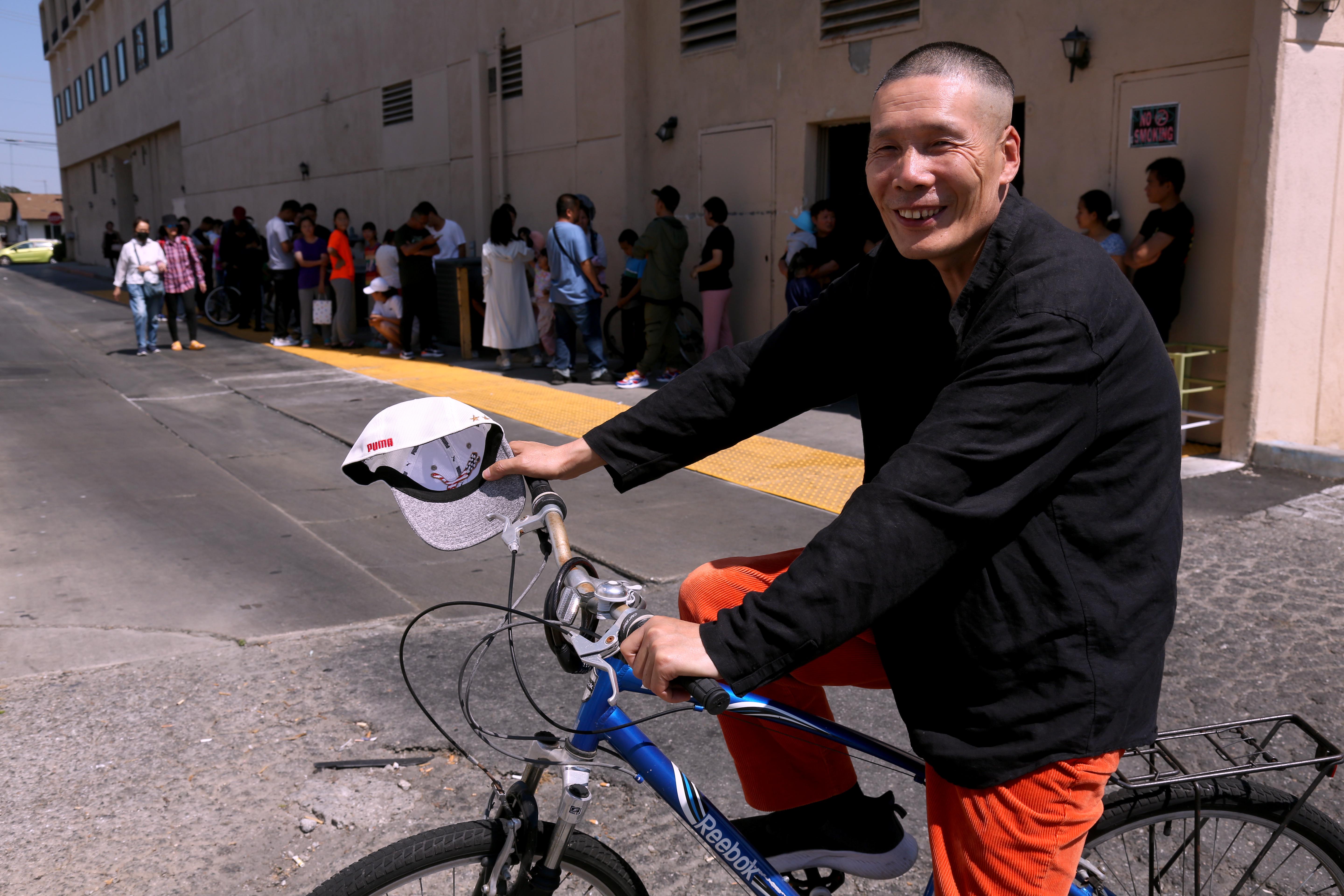 Xuewen Wang rests on his bike in Monterey Park in June. Wang, who said he was a doctor in China, arrived in Los Angeles in March after flying to Turkey and then Ecuador and has since held a number of jobs. His goal now is to become an Uber driver and then a long-haul truck driver. (Genaro Molina/Los Angeles Times/TNS) Xuewen Wang rests on his bike in Monterey Park in June. Wang, who said he was a doctor in China, arrived in Los Angeles in March after flying to Turkey and then Ecuador and has since held a number of jobs. His goal now is to become an Uber driver and then a long-haul truck driver. (Genaro Molina/Los Angeles Times/TNS)