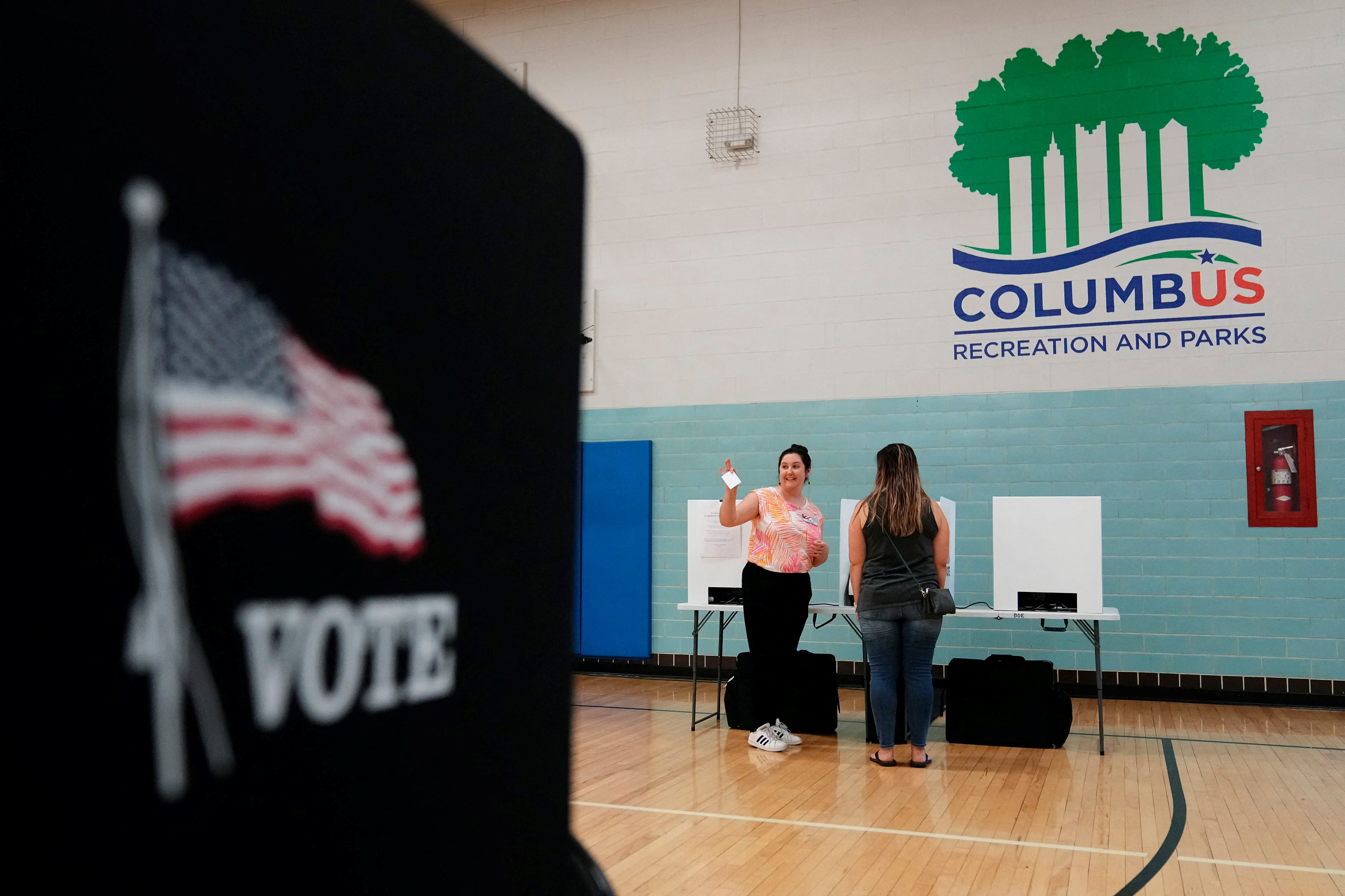 Volunteer Amelia Klein helps voters cast their ballots during a special election for Issue 1 at the Schiller Recreation Center in German Village in Columbus, Ohio, U.S. August 8, 2023. Adam Cairns/USA Today Network via REUTERS