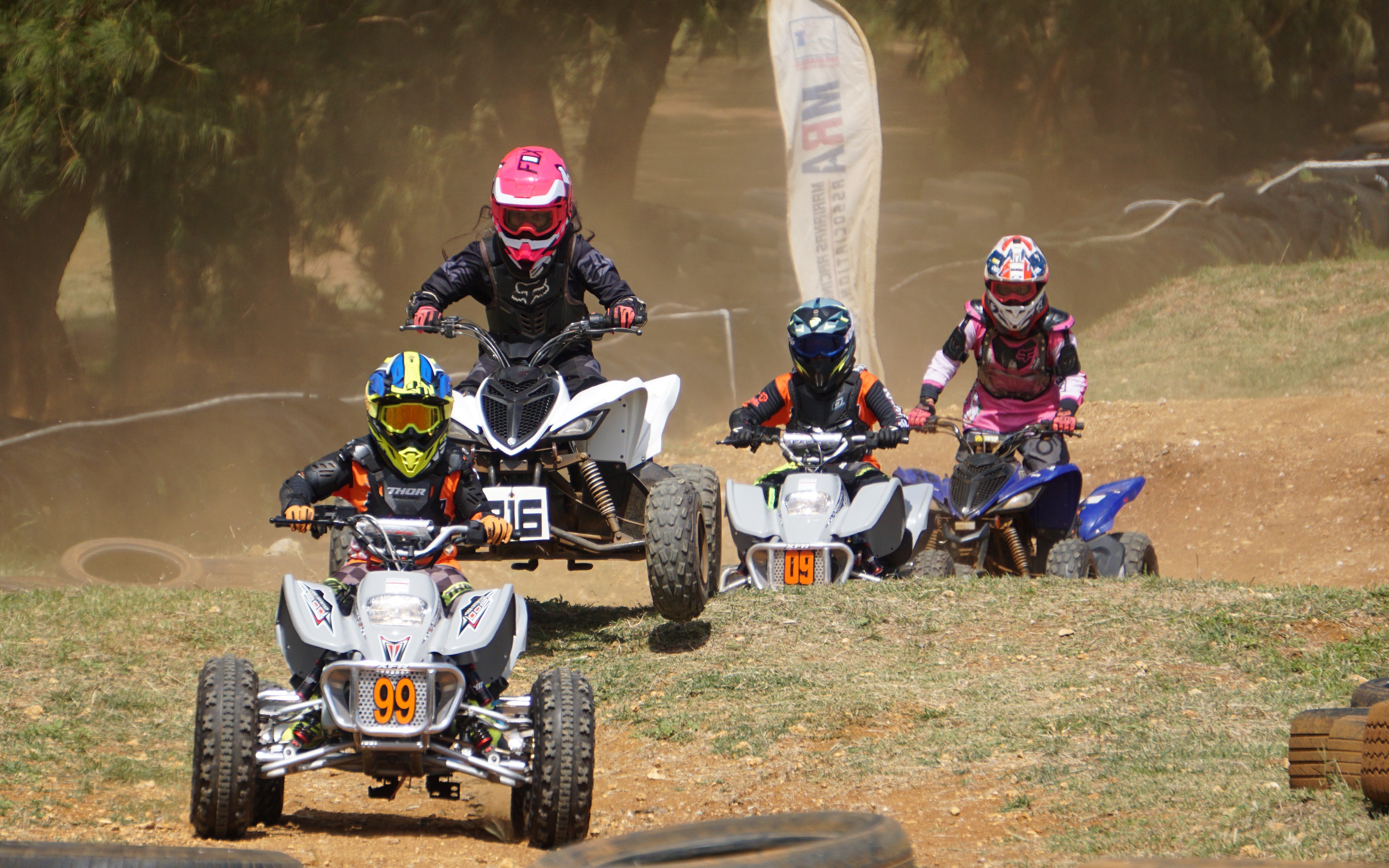 Anella Igitol, second left, battles for the lead during a Mini ATV race of the 2023 Marianas Racing Association Monster Energy Points Race Series at Cowtown Raceway Park.