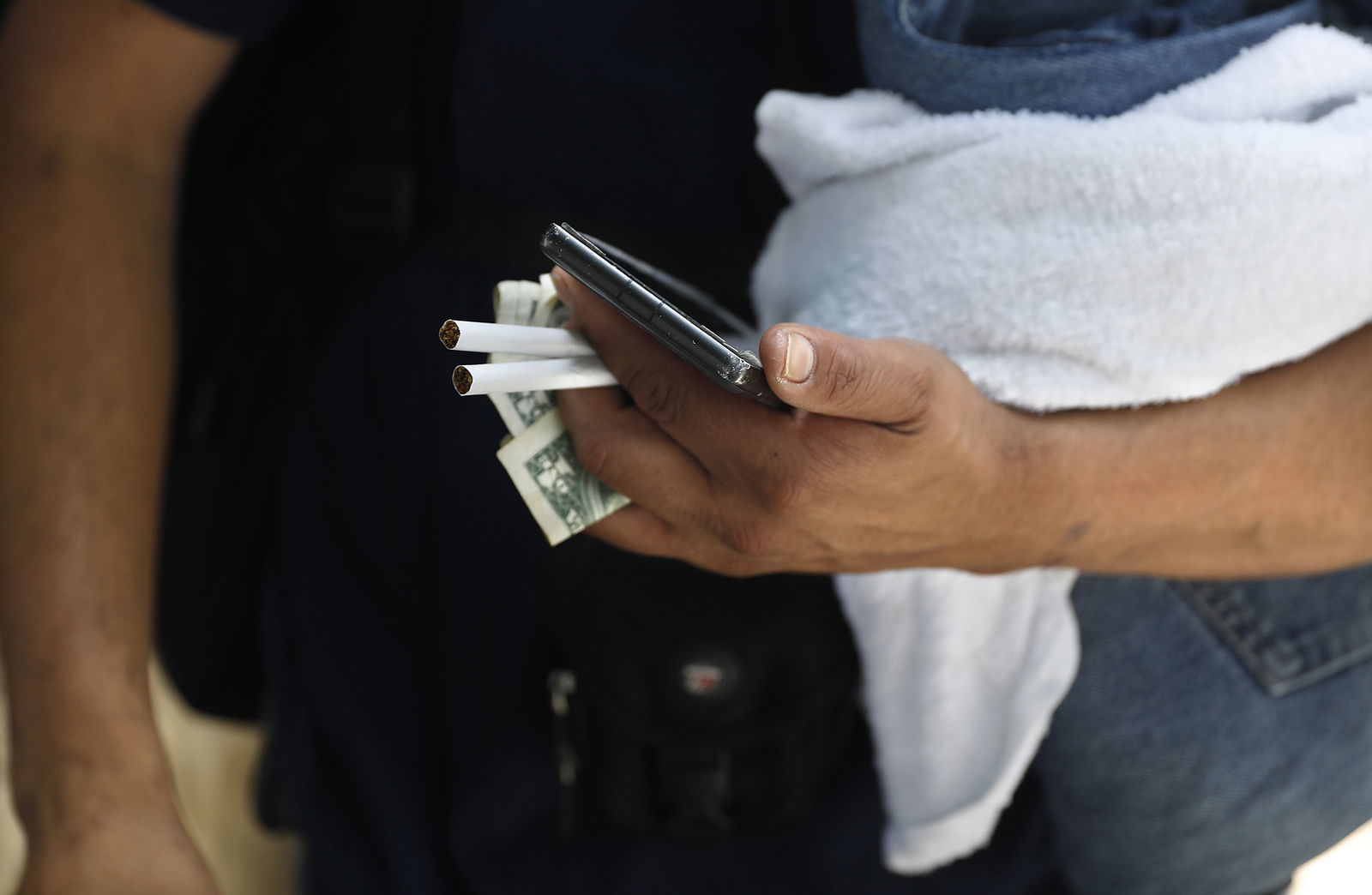 Jesus Franco holds cigarettes and money provided by crisis interventionist Vicki Lucas, in exchange for information that could lead to locating Sherry Hillâ€™s daughter on the streets of Pasadena, California, on July 21, 2023. (Christina House/Los Angeles Times/TNS)