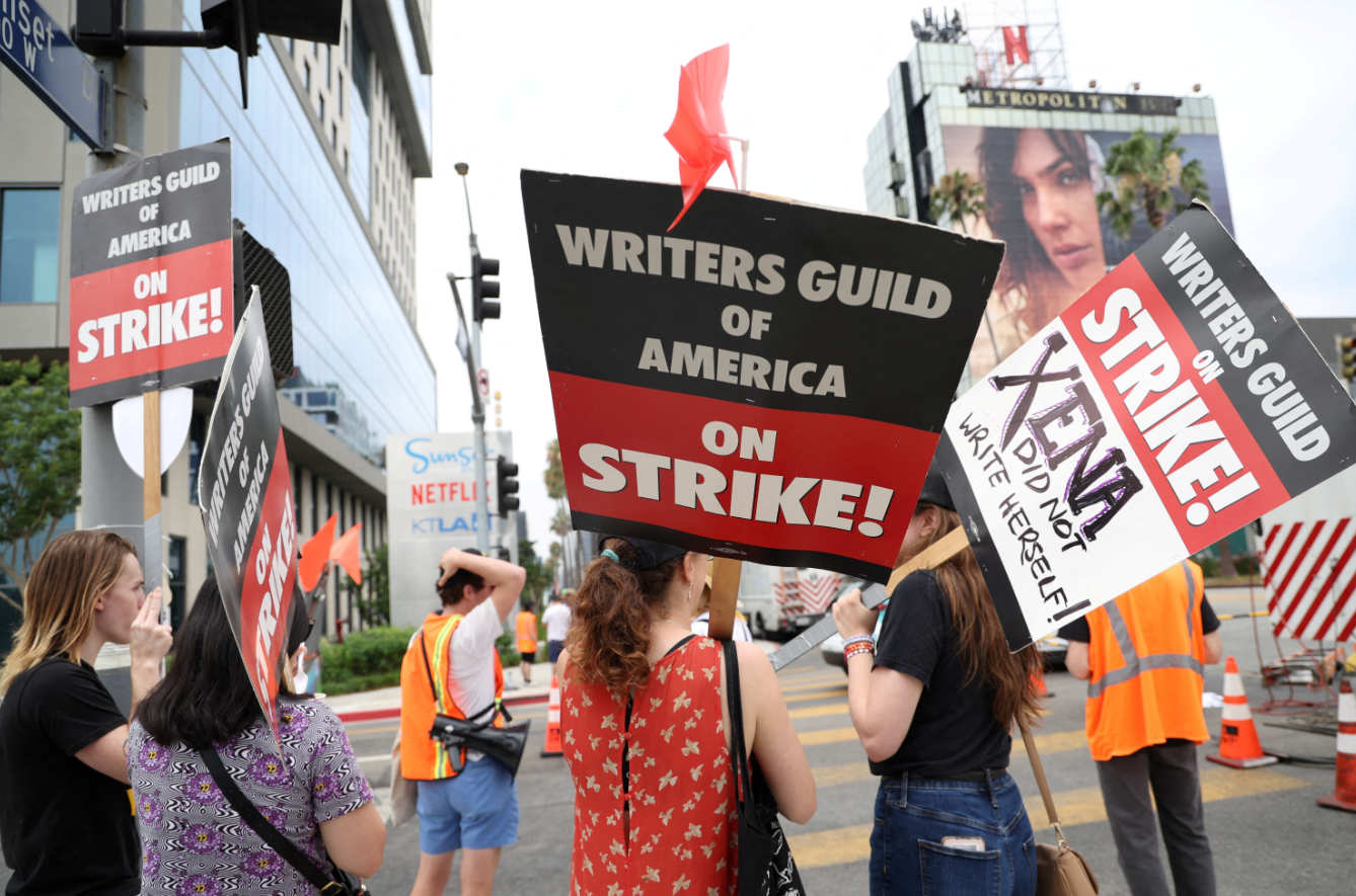 SAG-AFTRA actors and Writers Guild of America writers walk the picket line during their ongoing strike outside Sunset Bronson studios and Netflix offices in Los Angeles, California, Aug. 11, 2023.