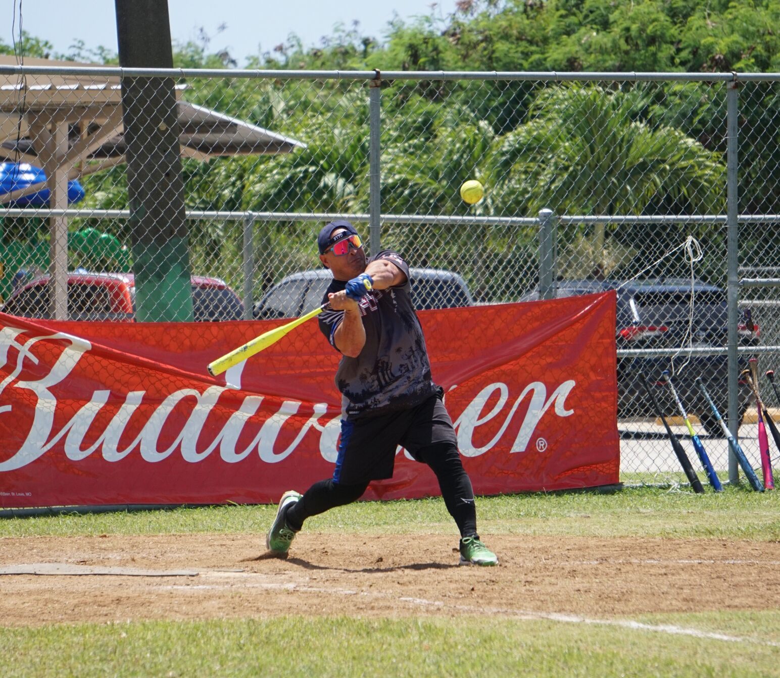 No Excuse's Audie Maratita swings and connects for a homerun during a Budweiser Belau Amateur Softball Association Open League game at the Dandan baseball field.