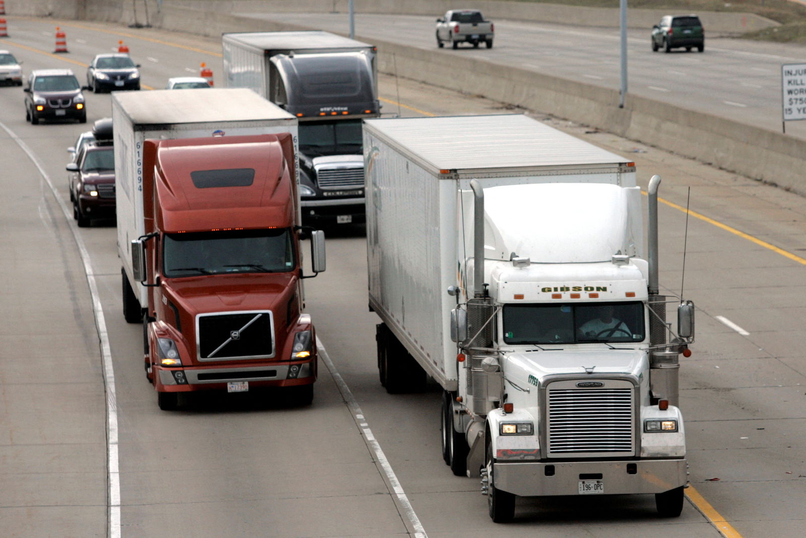 Two freight trucks are driven on the Fisher freeway in Detroit, Michigan, March 27, 2009.