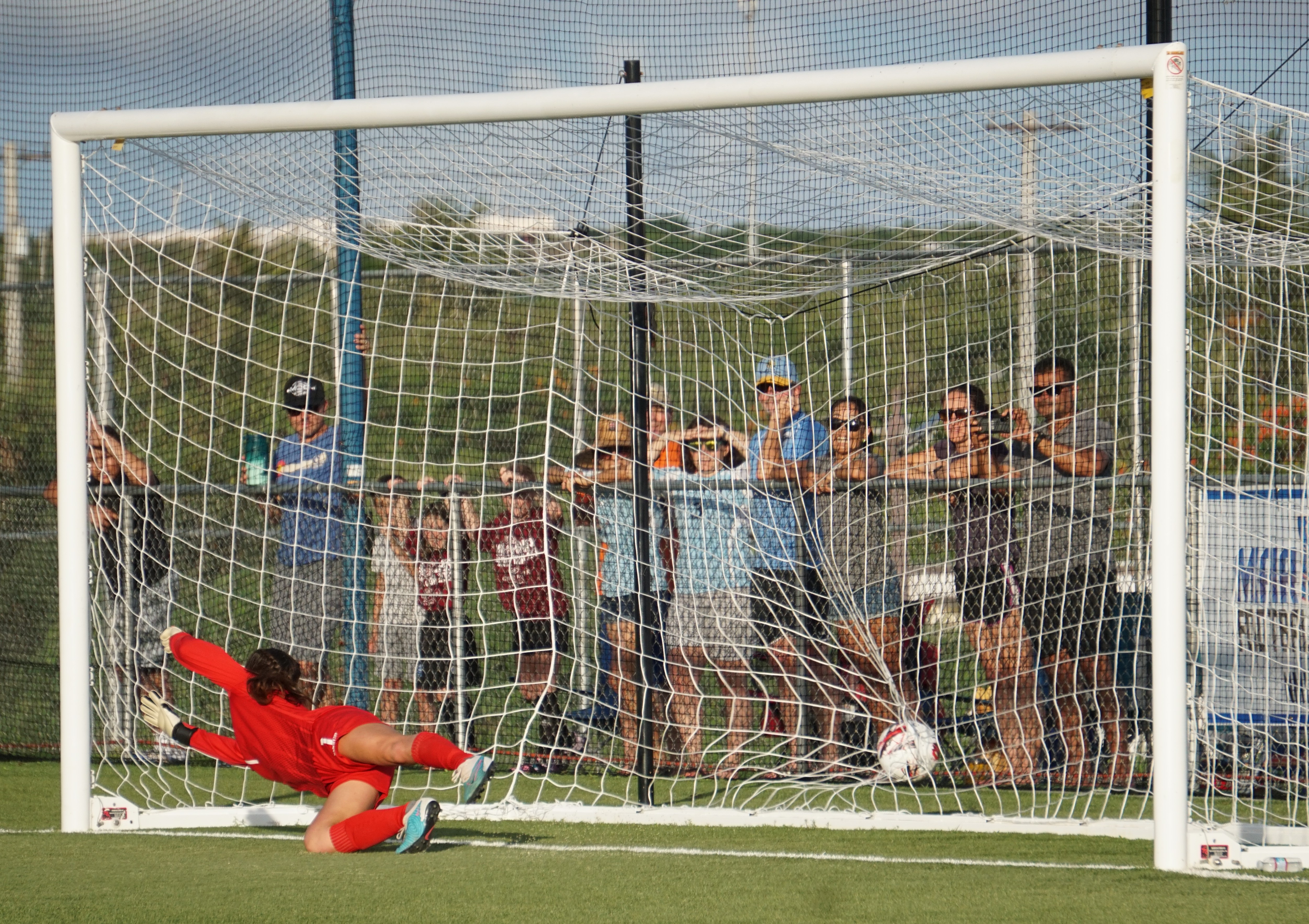 The NMI finds the back of the net after slipping past Guam goalkeeper Ha'ani Bylerly during a Marianas Football Cup game Thursday at the NMI Soccer Training Center in Koblerville..
