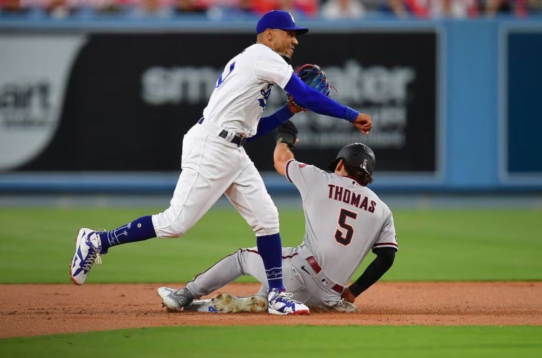 Arizona Diamondbacks center fielder Alek Thomas (5) is out at second as Los Angeles Dodgers second baseman Mookie Betts (50) throws to first for the out against left fielder Lourdes Gurriel Jr. (12) during the second inning at Dodger Stadium in Los Angeles, California, Aug. 28, 2023.