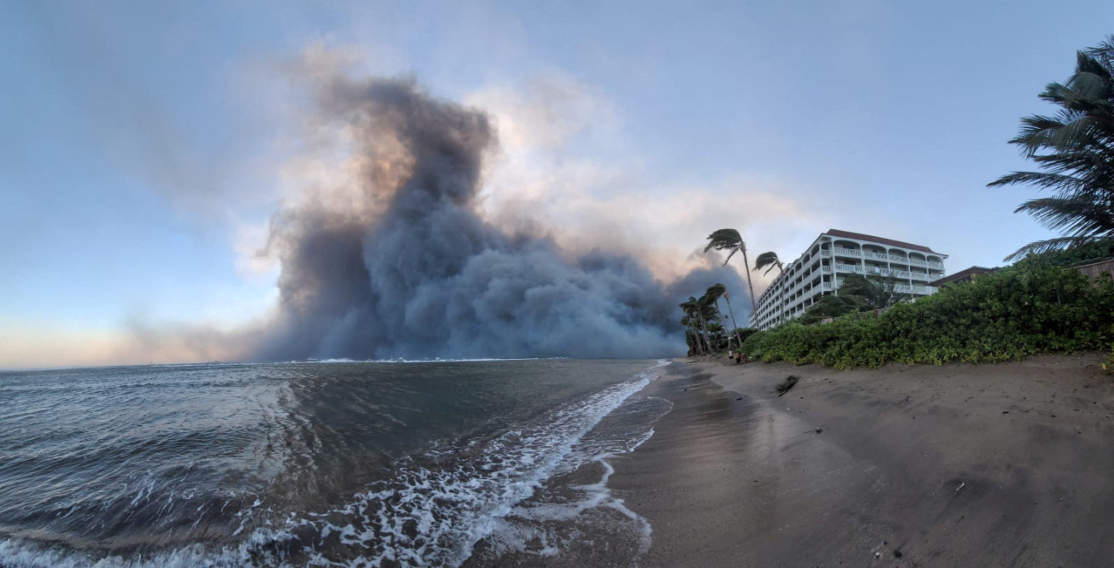 Smoke billows near Lahaina as wildfires driven by high winds destroy a large part of the historic town of Lahaina, Hawaii, U.S. August 9, 2023. Dustin Johnson/Handout via REUTERS