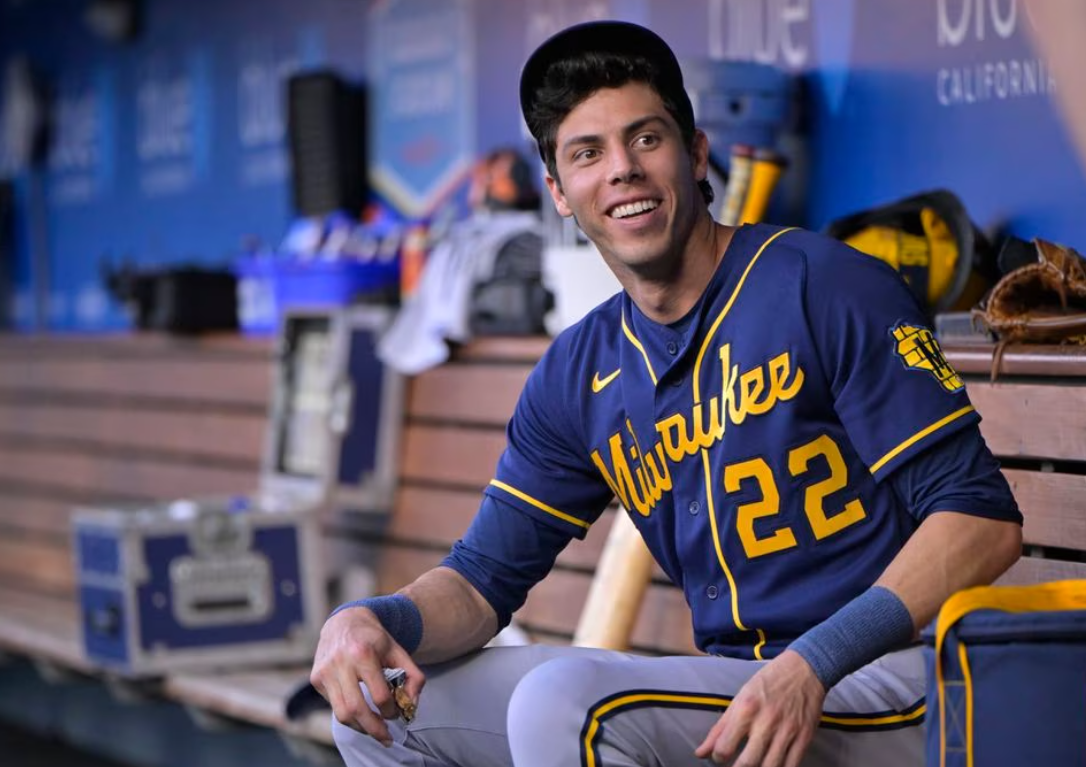 Milwaukee Brewers left fielder Christian Yelich (22) sits in the dugout prior to the game against the Los Angeles Dodgers at Dodger Stadium in Los Angeles, California, Aug. 16, 2023.