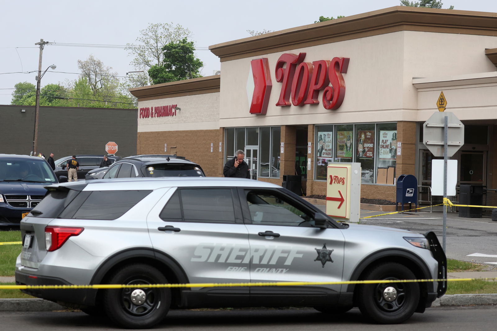 Members of law enforcement work at the scene of a weekend shooting at a Tops supermarket in Buffalo, New York, U.S. May 19, 2022. REUTERS/Brendan McDermid/File Photo