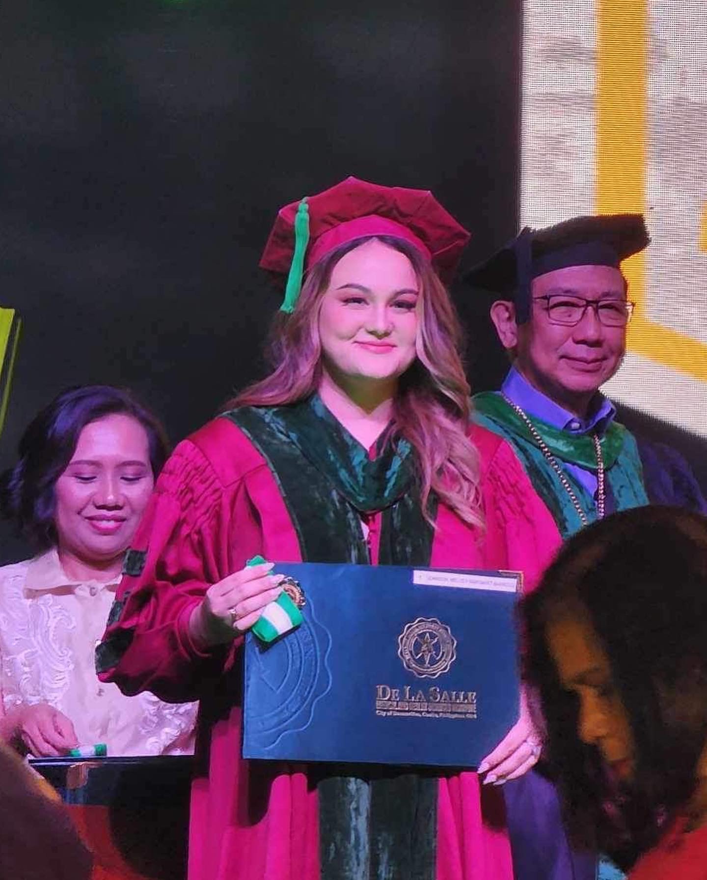 Melody Margaret B. Johnson graduates from the De La Salle Medical and Health Sciences Institute in Cavite, the Philippines.