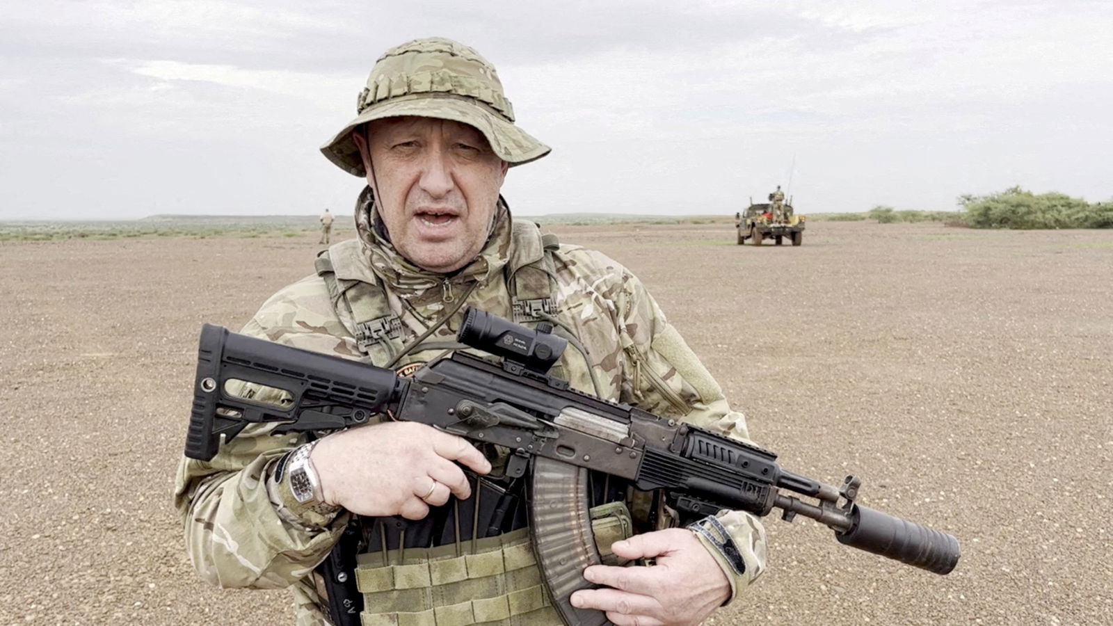 The late Yevgeny Prigozhin, chief of Russian private mercenary group Wagner, then giving an address in camouflage and with a weapon in his hands in a desert area at an unknown location, in this still image taken from video possibly shot in Africa and published August 21, 2023. Courtesy PMC Wagner via Telegram via REUTERS/File Photo