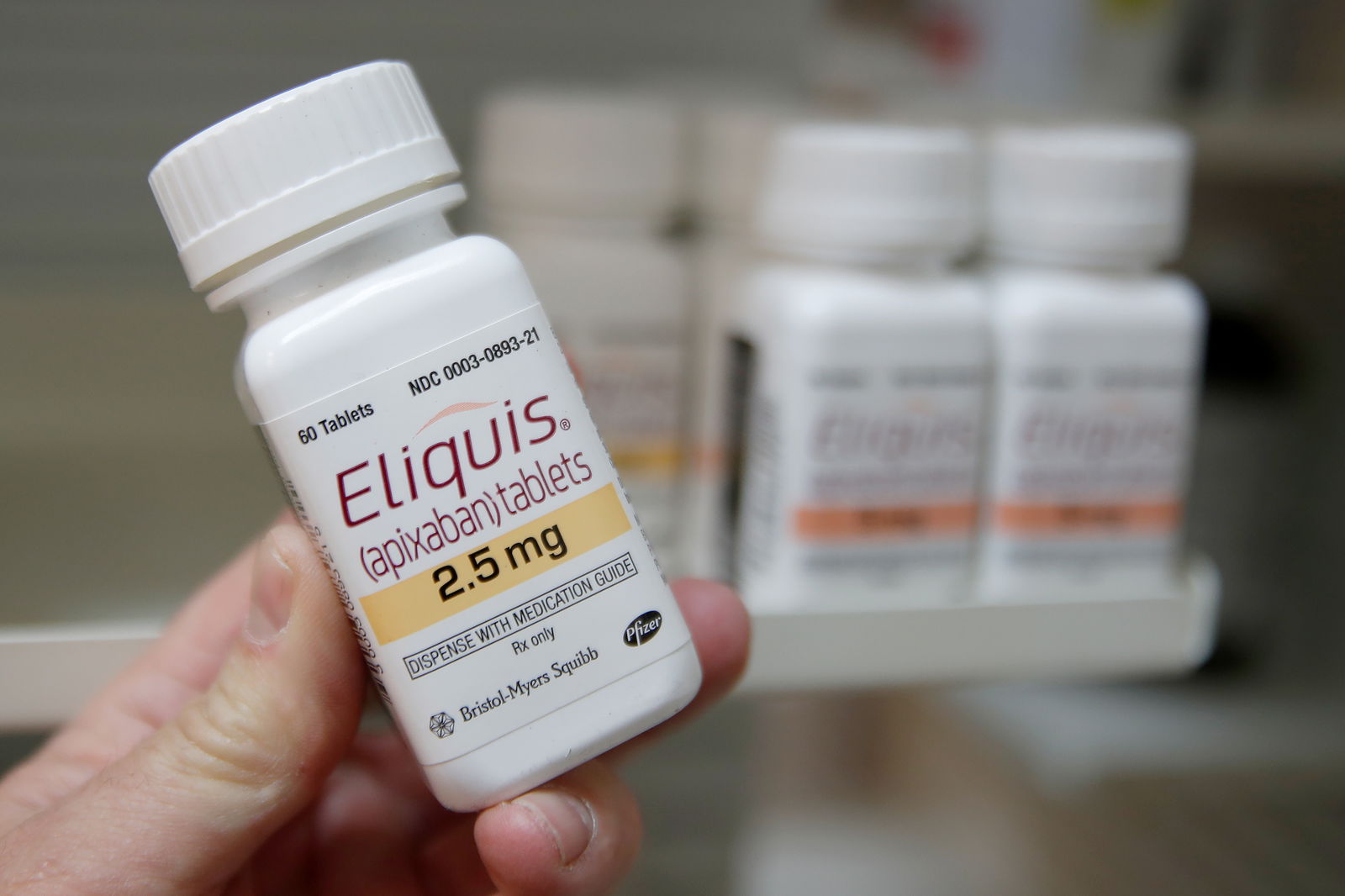 A pharmacist holds a bottle of the drug Eliquis, made by Pfizer Pharmaceuticals, at a pharmacy in Provo, Utah, U.S. January 9, 2020. REUTERS/George Frey/File photo