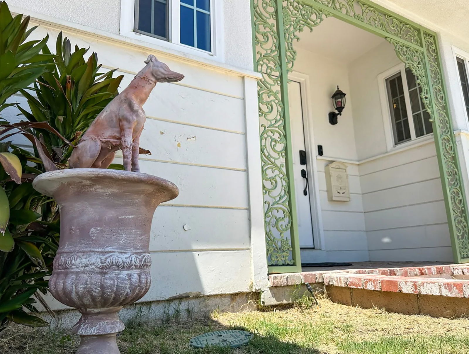 The outside of a Haunted Mansion-themed Airbnb features green wrought iron and animal statues on July 17, 2023, in Fullerton, California. (Jeff Gritchen/Orange County Register/TNS)
