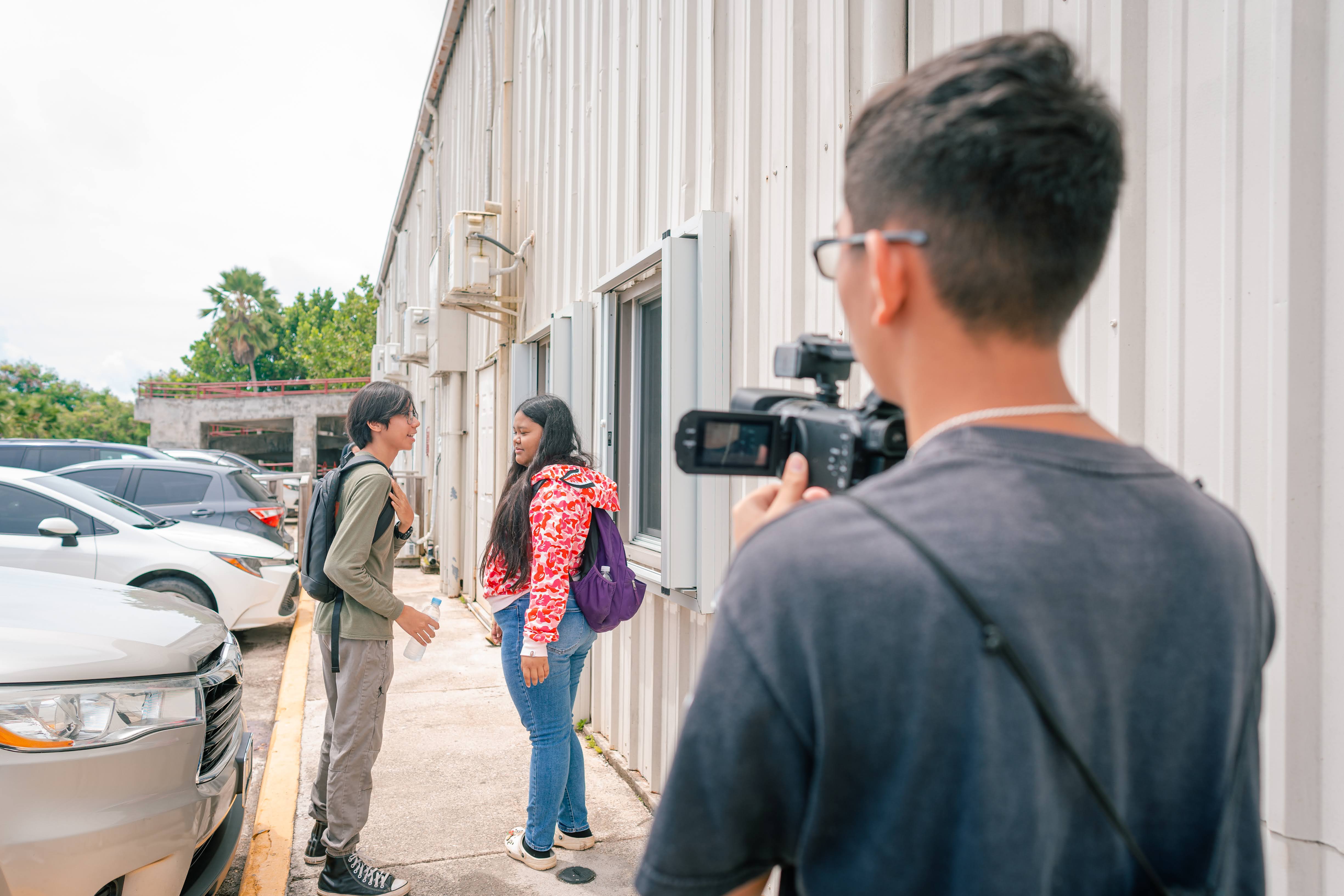 From left, Jared Ortiz and Soulynna Camacho film a scene with Wayne Takai.