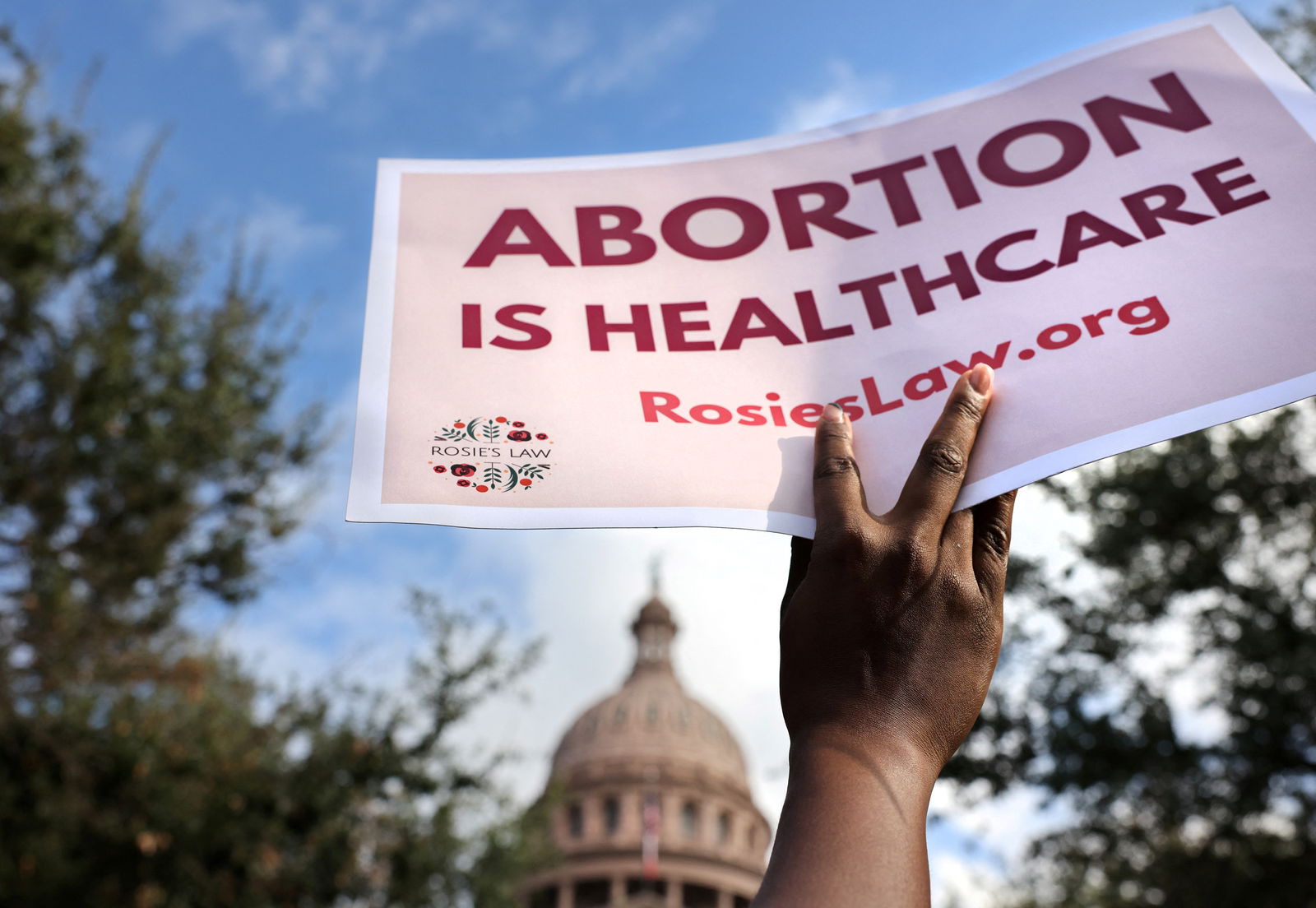 A supporter of reproductive rights holds a sign outside the Texas State Capitol building during the nationwide Women's March, held after Texas rolled out a near-total ban on abortion procedures and access to abortion-inducing medications, in Austin, Texas, U.S. October 2, 2021. REUTERS/Evelyn Hockstein/File Photo