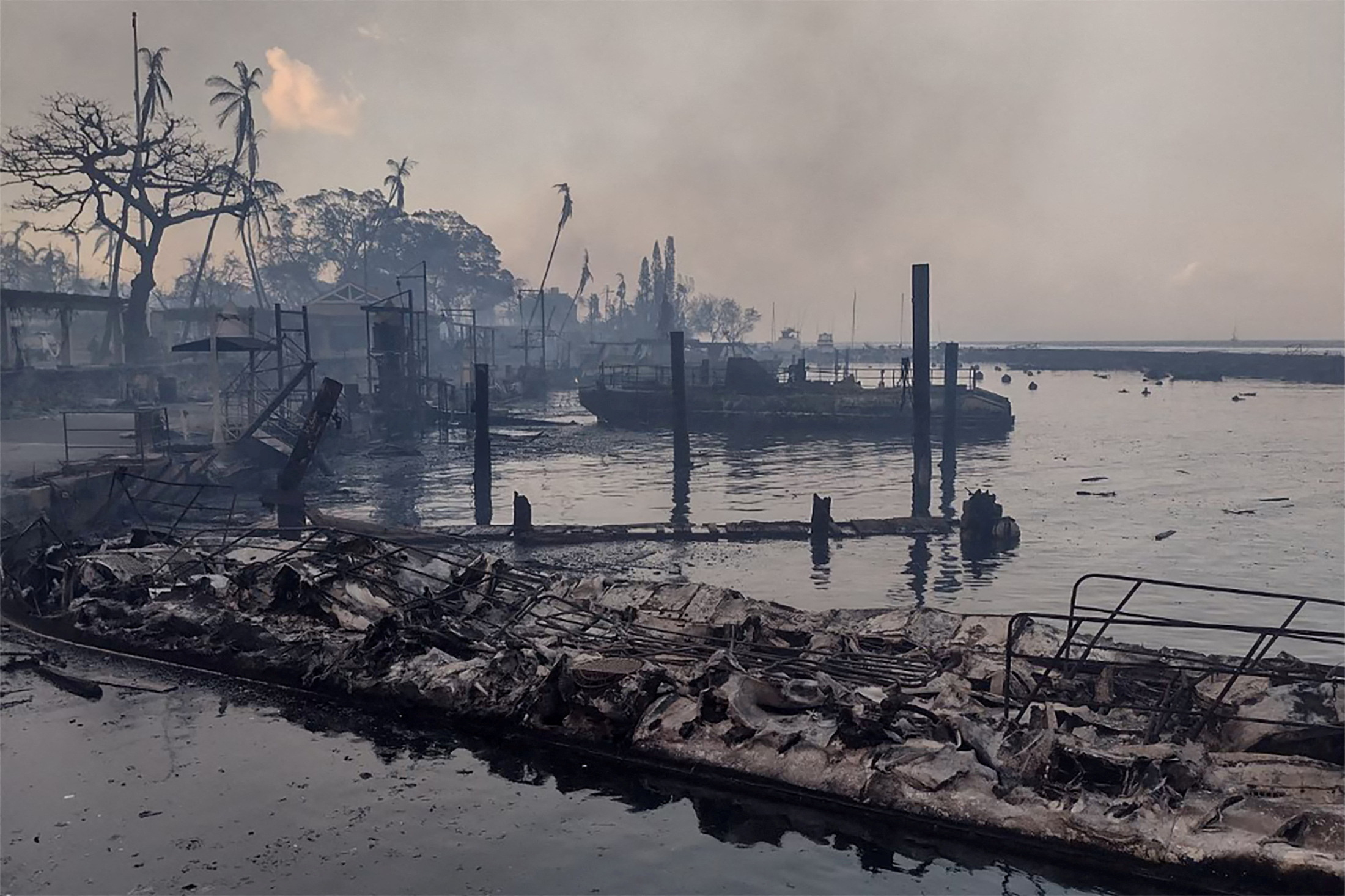 A charred boat lies in the scorched waterfront after wildfires fanned by the winds of a distant hurricane devastated Maui's city of Lahaina, Hawaii, U.S. August 9, 2023. Mason Jarvi/Handout via REUTERS