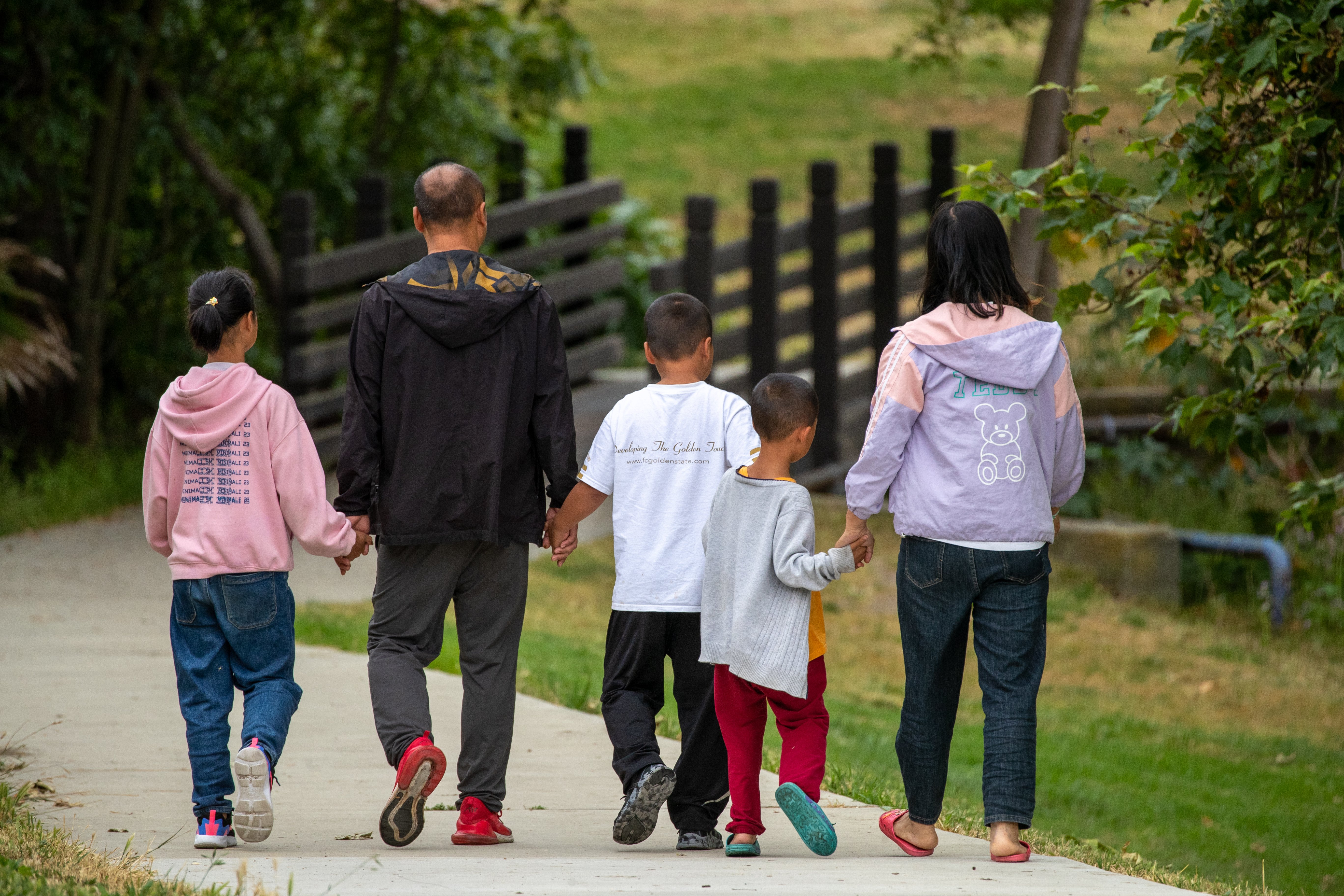 Shidong Liang, second from left, walks with his wife and three children, ages 6, 7 and 10, at Peter F. Schabarum Regional Park in Rowland Heights on June 15. The family reached the Los Angeles area on June 6 after a journey that included crossing the dangerous Darien Gap. (Irfan Khan/Los Angeles Times/TNS)