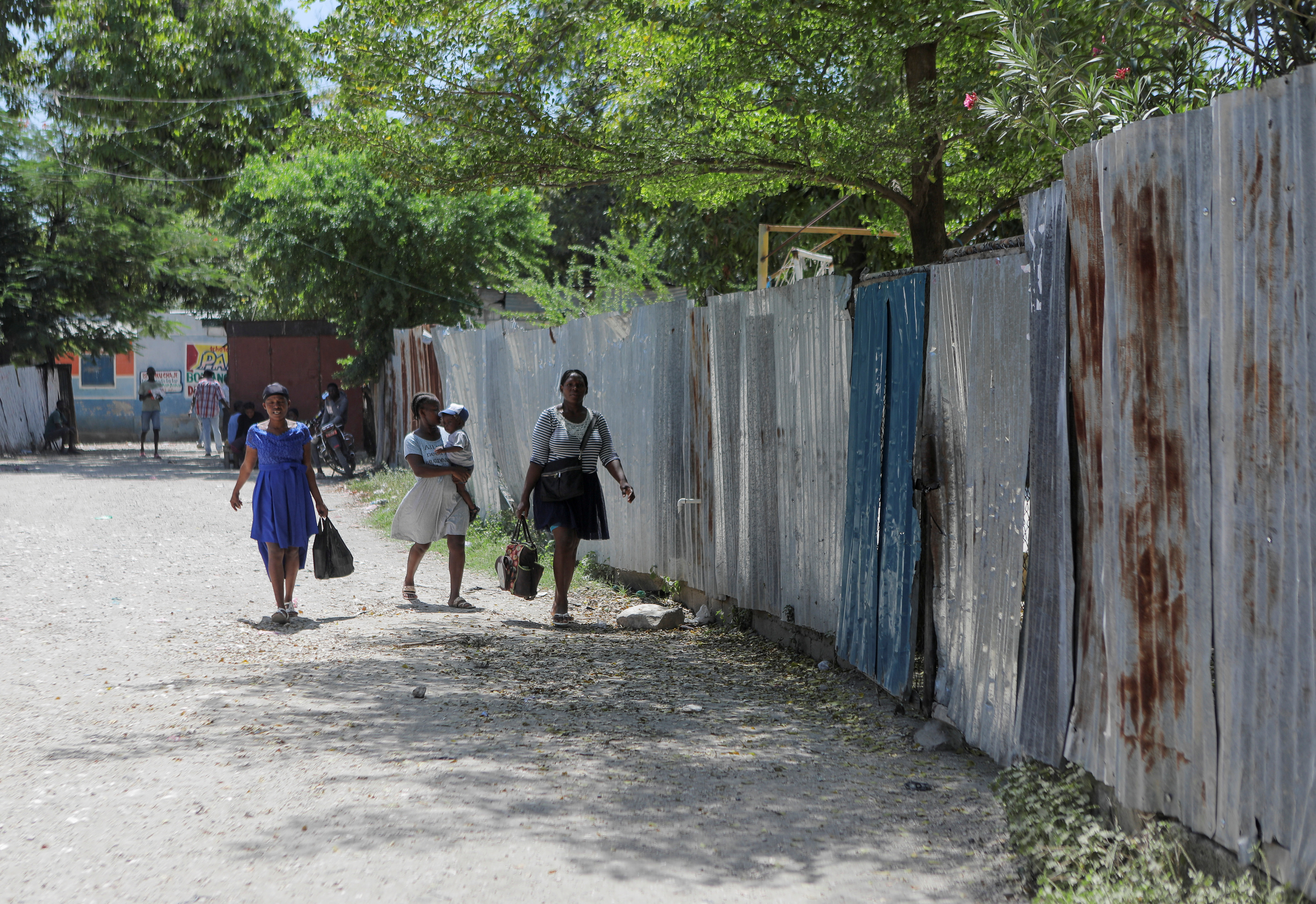 People walk past the installations of the humanitarian aid organization El Roi Haiti after U.S. nurse Alix Dorsainvil and her child were safely released following their kidnapping in Haiti two weeks ago, in Cite Soleil, in Port-au-Prince, Haiti August 9, 2023. REUTERS/Ralph Tedy Erol