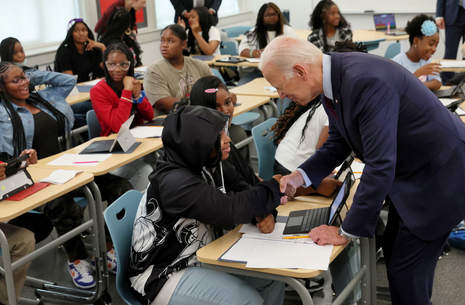 U.S. President Joe Biden greets a student on their first day back to school at Eliot-Hine Middle School in Washington, U.S., August 28, 2023. REUTERS/Leah Millis