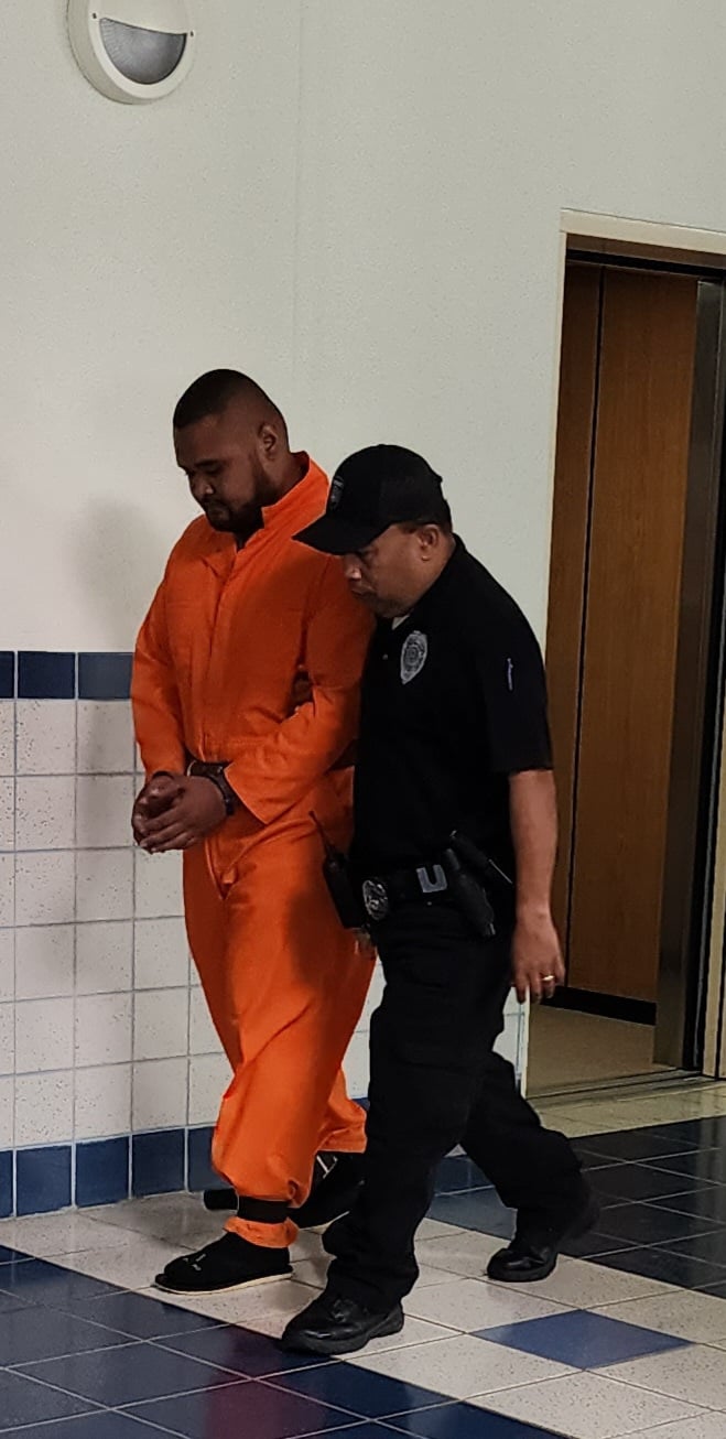 Raymond Lizama Saralu, 27 walks to courtroom 220 under custody of a Corrections Officer Monday morning for a bail hearing before Superior Court Judge Joseph N. Camacho.