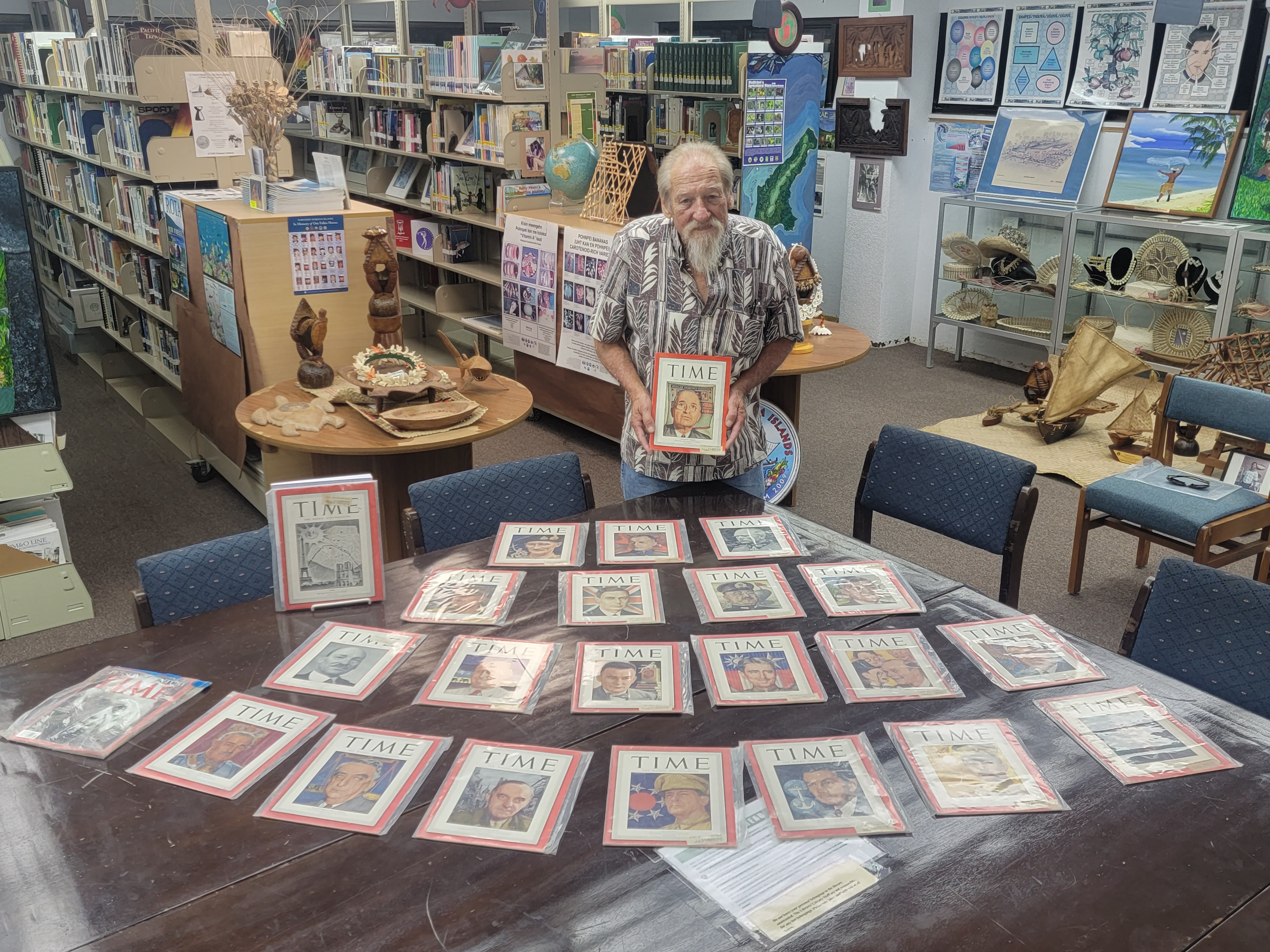 Don Farrell with his Time magazine donation in the Pacific Room of Joeten-Kiyu Public Library.