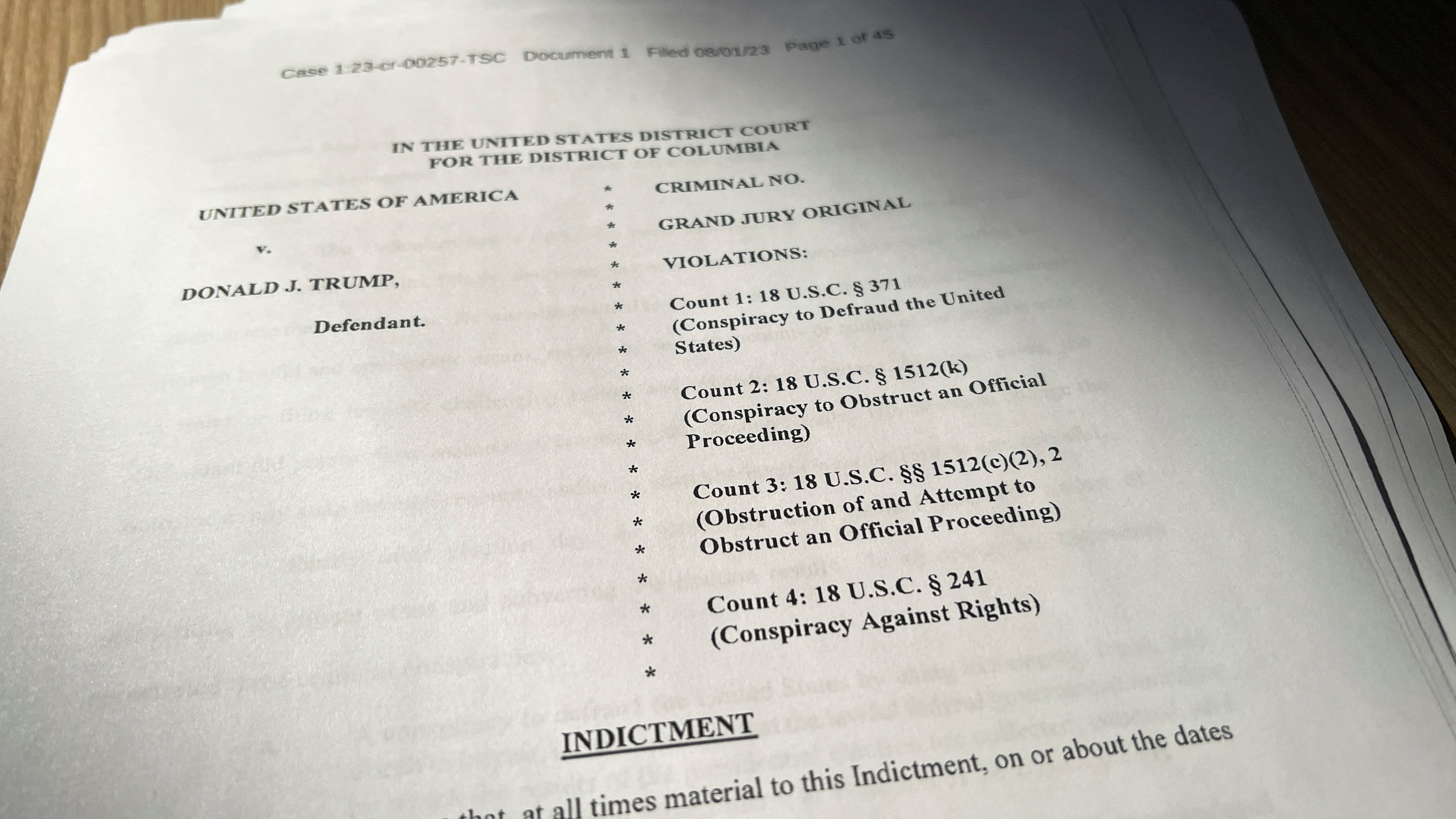 The list of four charges on the openng page of an indictment against former U.S. President Donald Trump is seen after he was hit with criminal charges for a third time in four months - this time arising from efforts to overturn his 2020 U.S. election defeat, in a photo illustration August 1, 2023. REUTERS/Kevin Fogarty/Photo Illustration