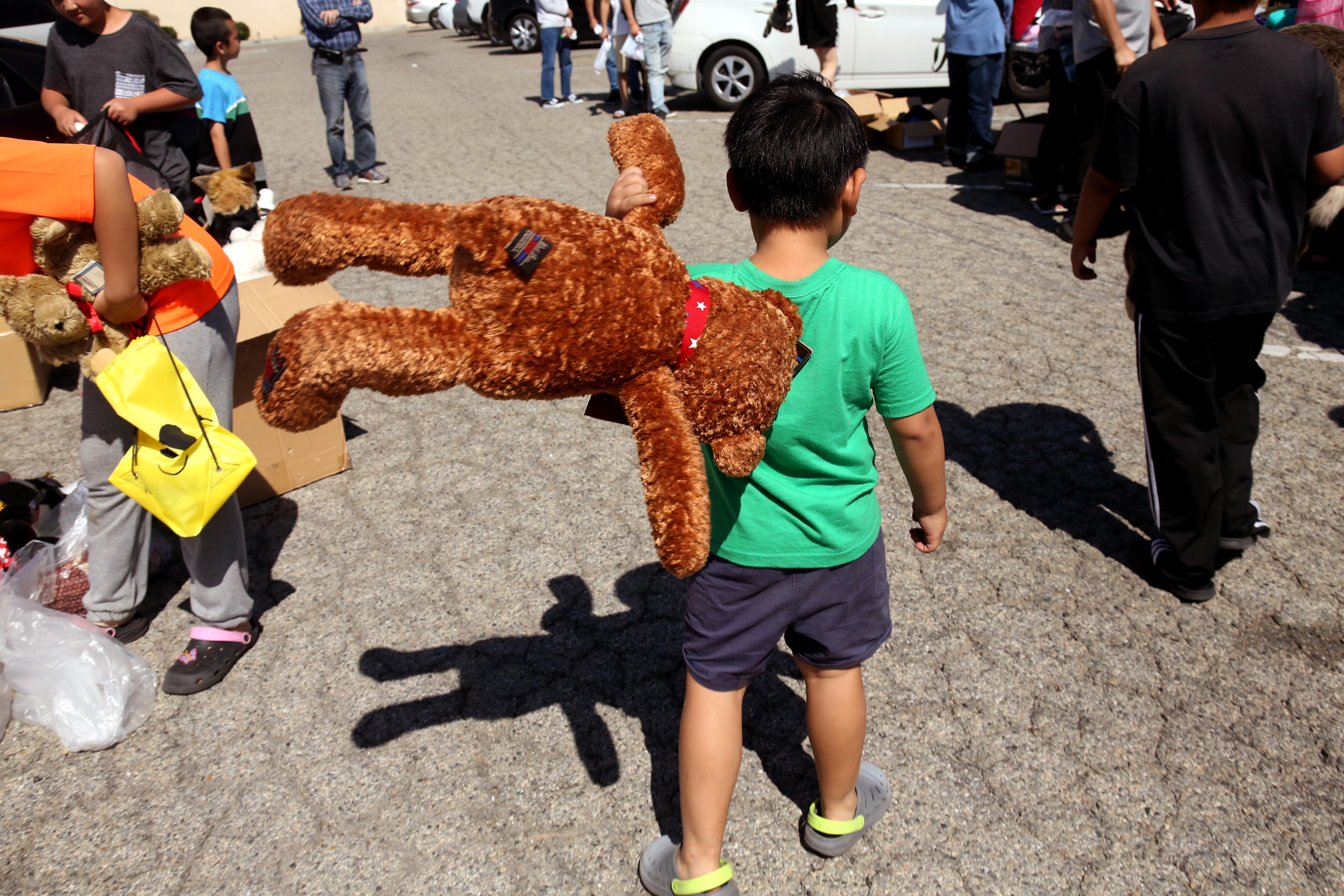 A migrant child walks with a stuffed animal at a free distribution of clothing, books and toys in Monterey Park in June. (Genaro Molina/Los Angeles Times/TNS) A migrant child walks with a stuffed animal at a free distribution of clothing, books and toys in Monterey Park in June. (Genaro Molina/Los Angeles Times/TNS)