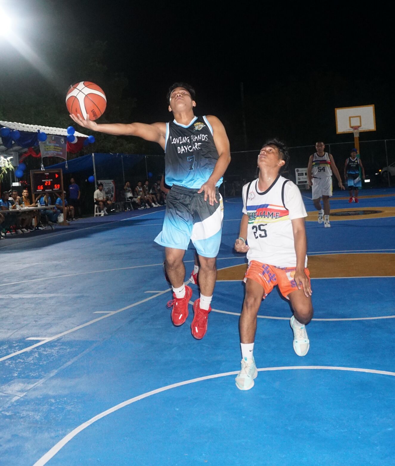Loving Hands' Aldrin Dancel extends for the finish during the opening game of the 2023 Saipan MagaLahi Eagles Club Invitational Basketball League at the Gualo Rai basketball court on Sunday.