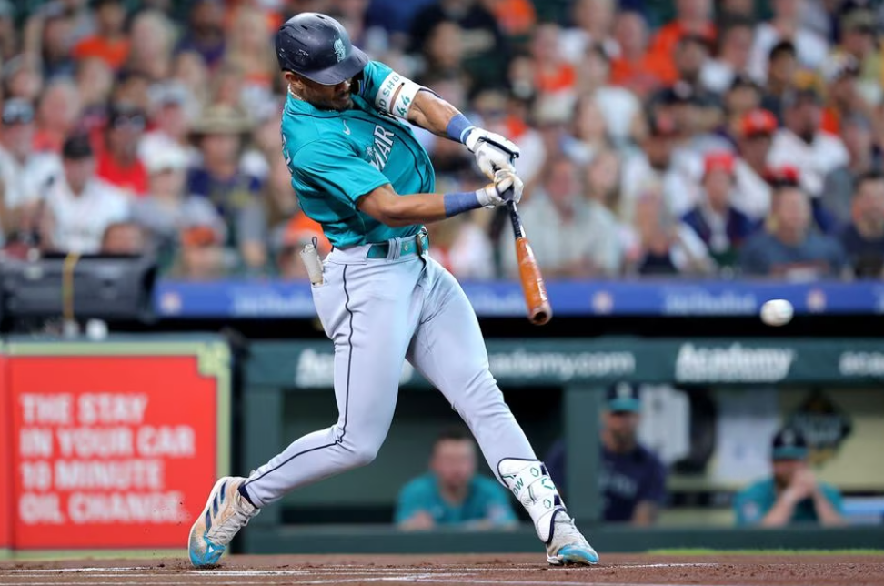 Seattle Mariners center fielder Julio Rodriguez (44) hits a single against the Houston Astros during the first inning during the first inning at Minute Maid Park in Houston, Texas, Aug. 19, 2023.
