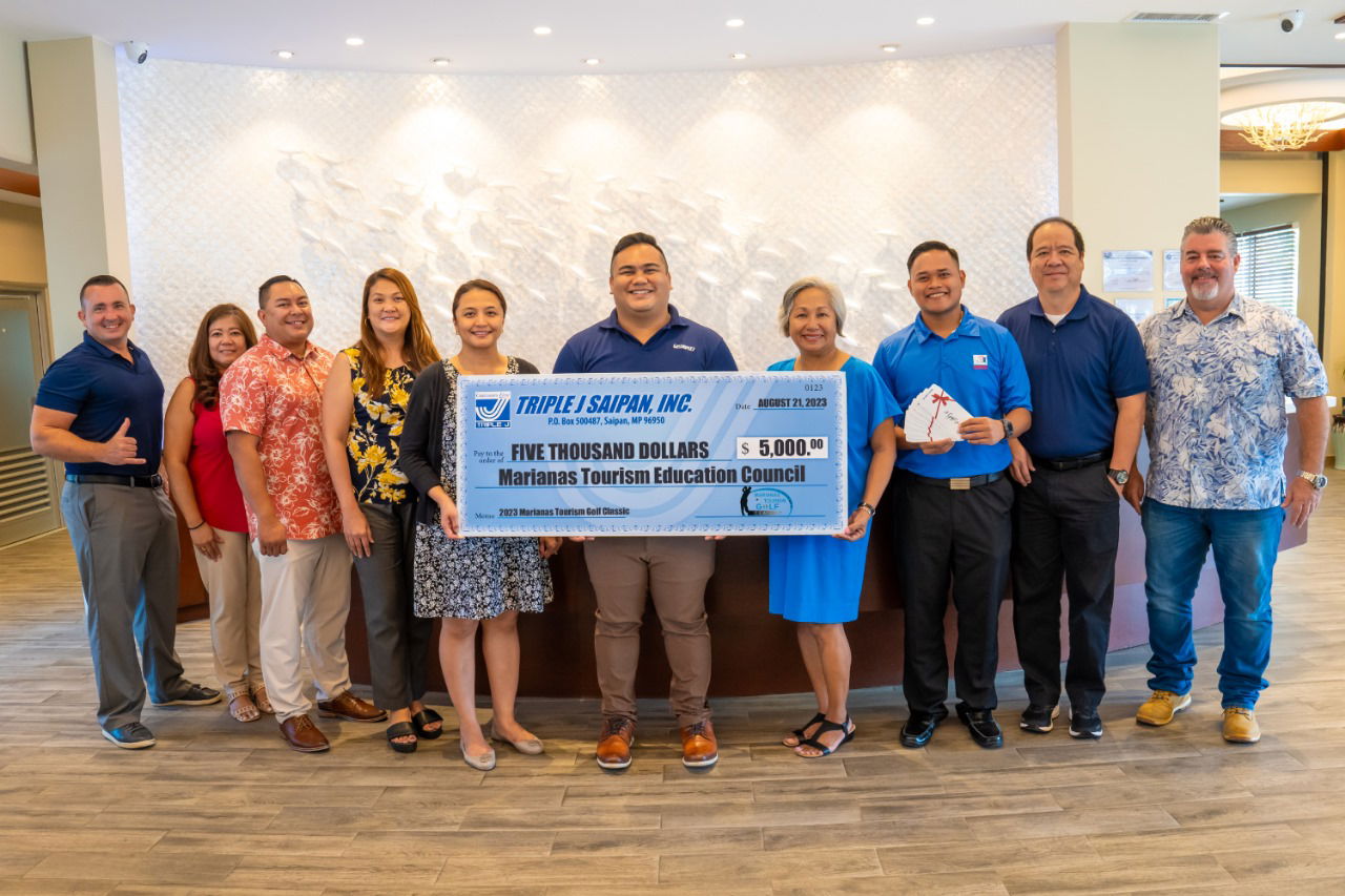 Triple J Marketing Manager Brad Ruszala, far left, and other management and staff present a $5,000 cash hole-in-one prize on Aug. 21, 2023, at Surfrider Resort in Chalan Kanoa, Saipan, for the Marianas Tourism Golf Classic to be held on Sept. 2, 2023, at LaoLao Bay Golf & Resort. From left, Ruszala, Triple J property manager Rachel Roque, Triple J business development manager Fred Camacho, Triple J executive assistant Micah Acuavera, Triple J corporate controller Kina Ann Peter, Triple J corporate counsel Jose Mafnas, Marianas Tourism Education Council  Chairwoman  Victoria  Benavente,  Marianas  Visitors  Authority  Community Projects Specialist Jack Aranda, MTEC Board Secretary and tournament committee chairman Martin Duenas, and Triple J superintendent construction operations Mario Valentino.