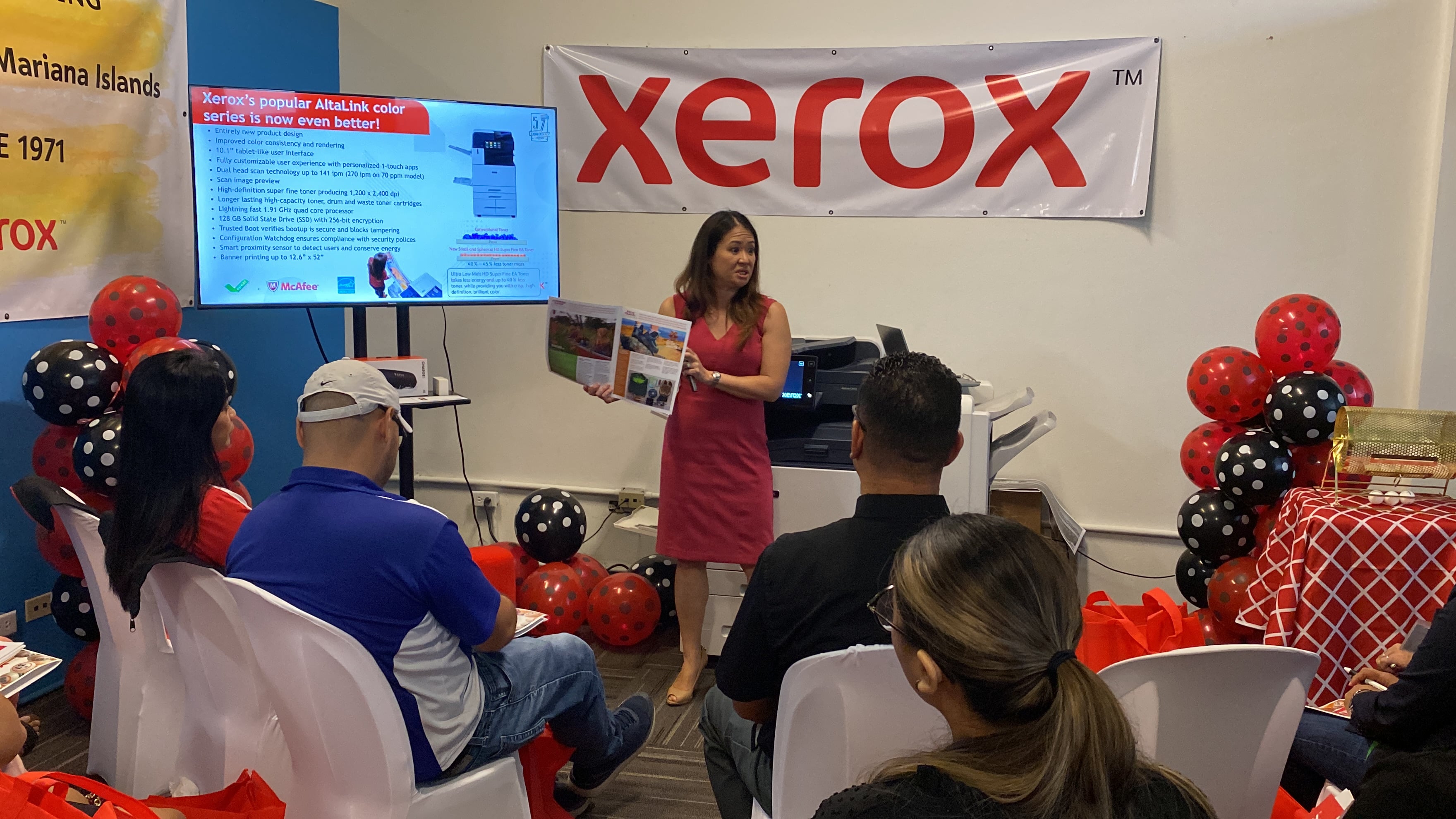 Tiffany Rabacal-Harper holds one of the booklets that can be made using an AltaLink Xerox machine during a presentation Thursday at the Xerox office in Garapan.