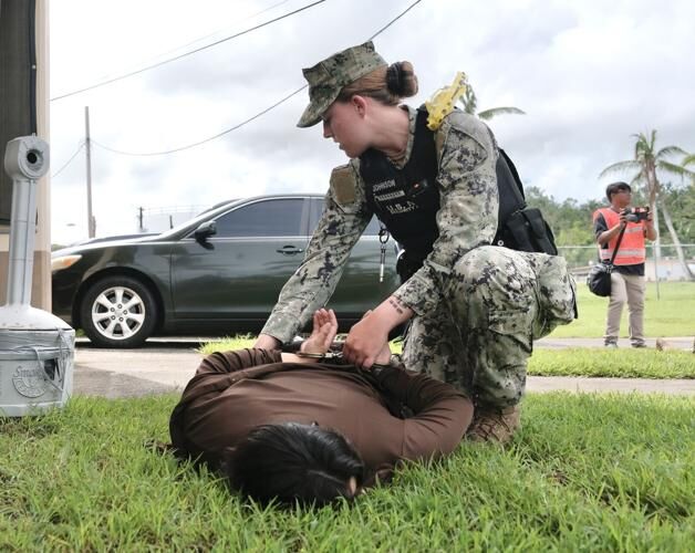 A Navy Security Forces officer detains a person role-playing as an active shooter during a drill at the Sasa Valley Fuel Farm in Piti on Wednesday, Aug. 23, 2023.