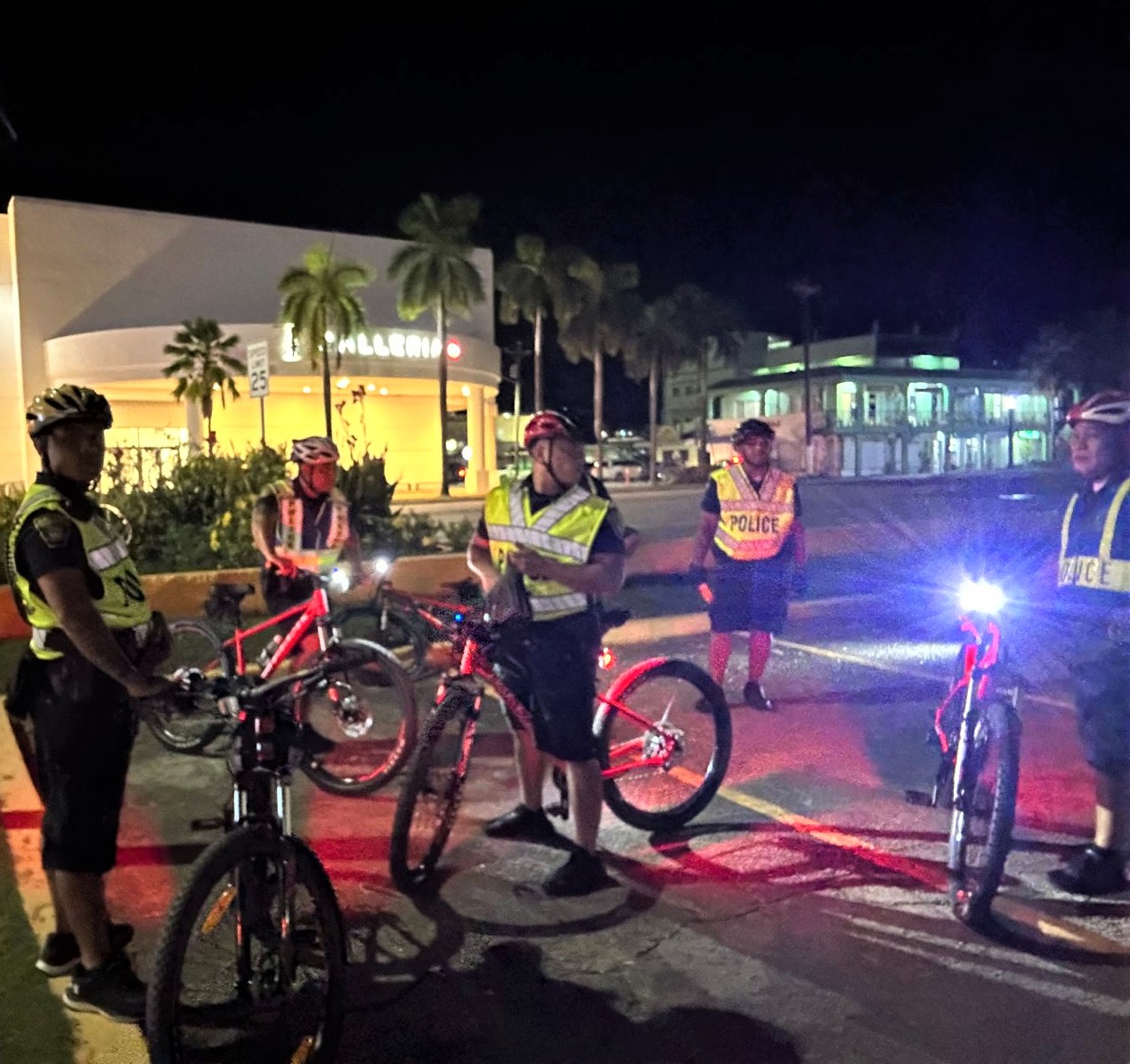 The Department of Public Safety bike patrol unit patrols the main tourist district of Garapan, Saipan in August 2023.